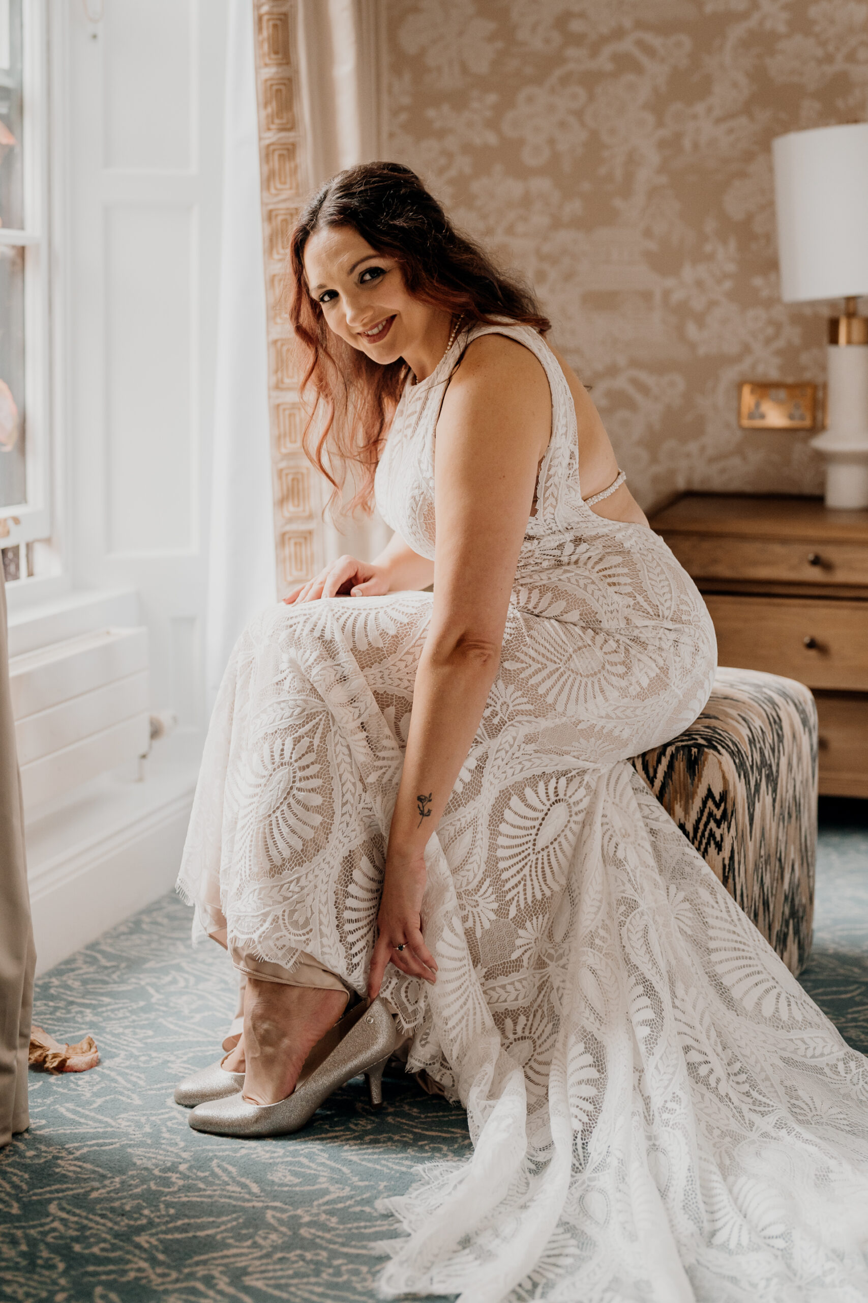 A woman in a dress sitting on a chair