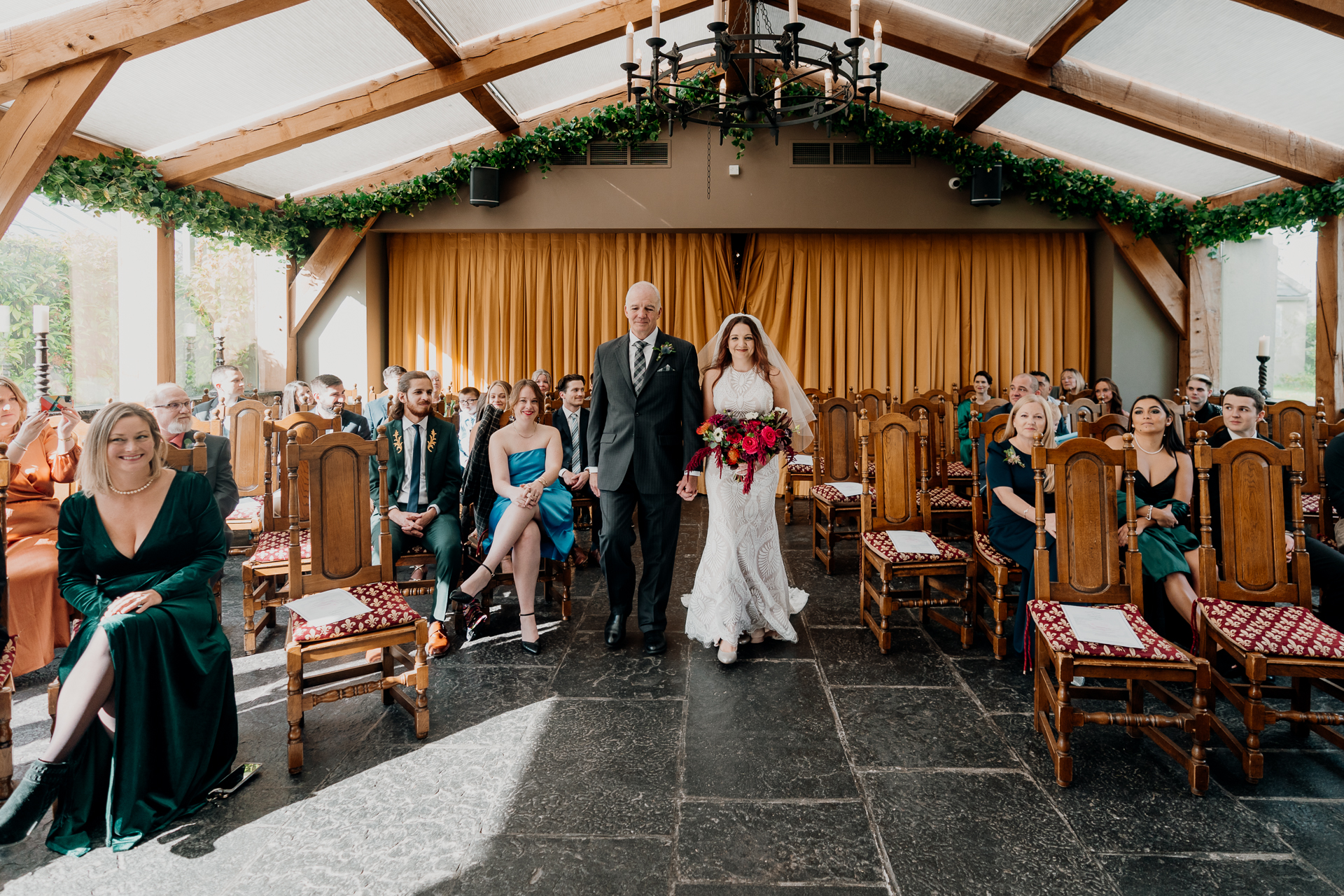 A man and woman walking down a aisle in a wedding ceremony