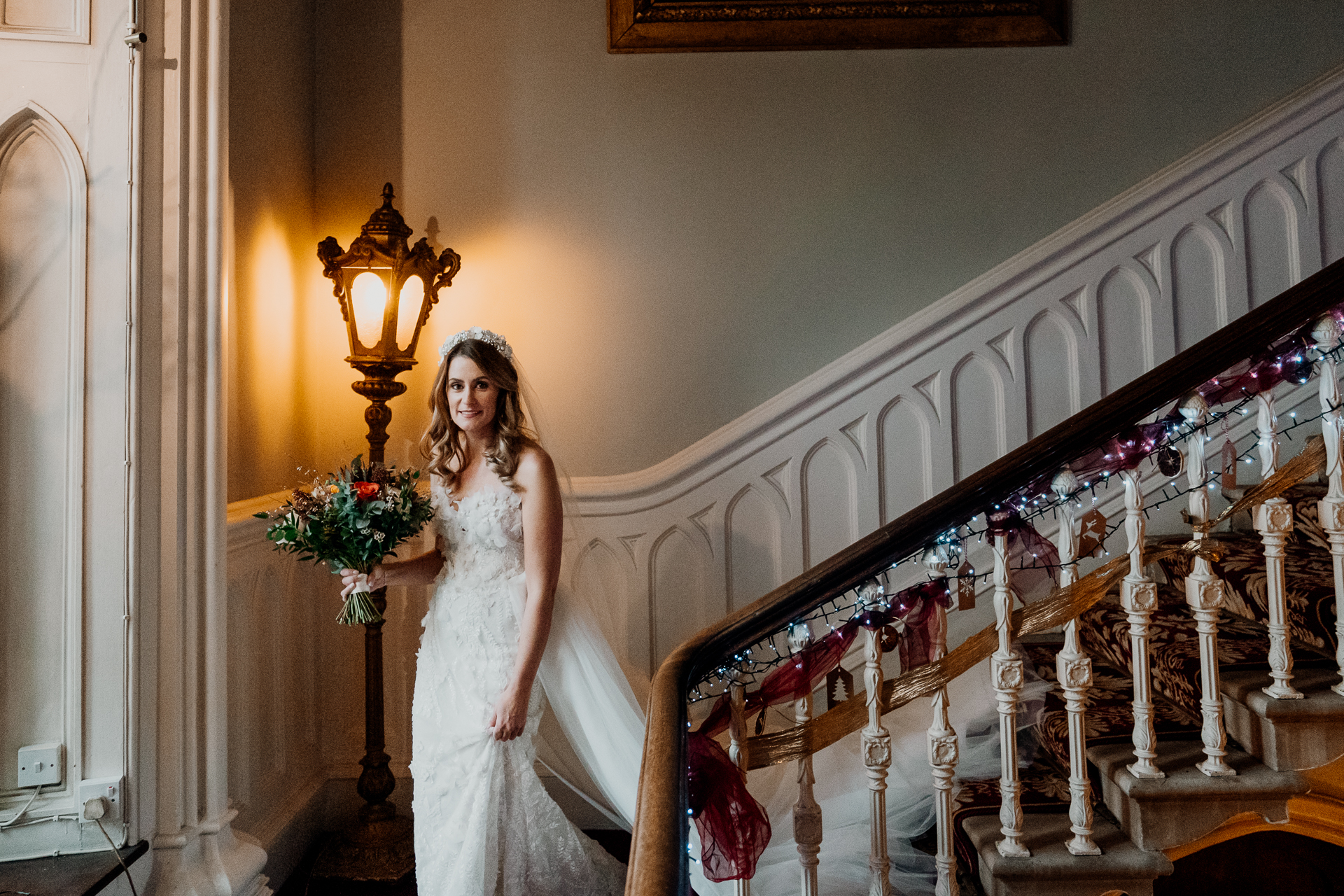 A person in a wedding dress standing on a staircase