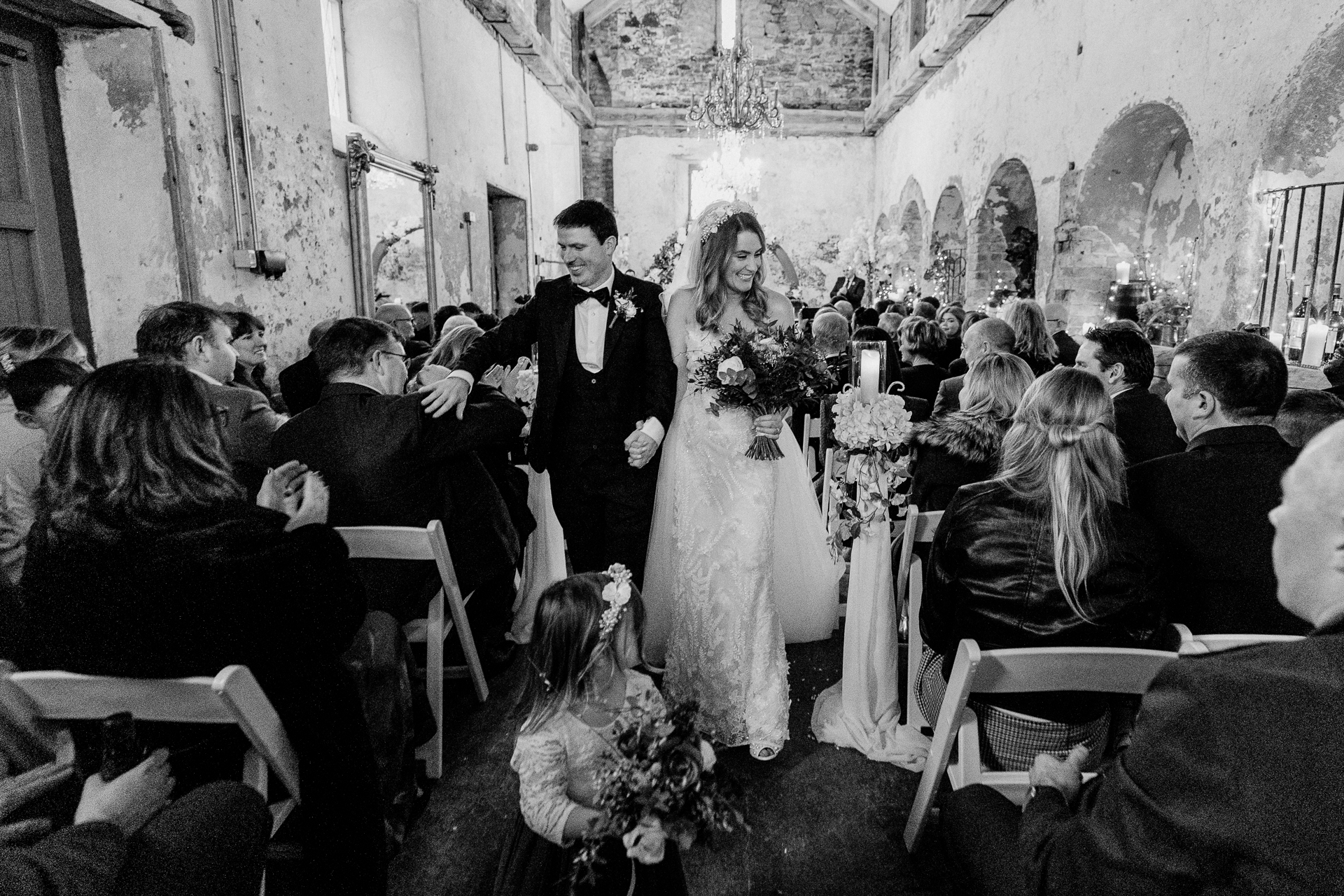 A bride and groom walking down the aisle