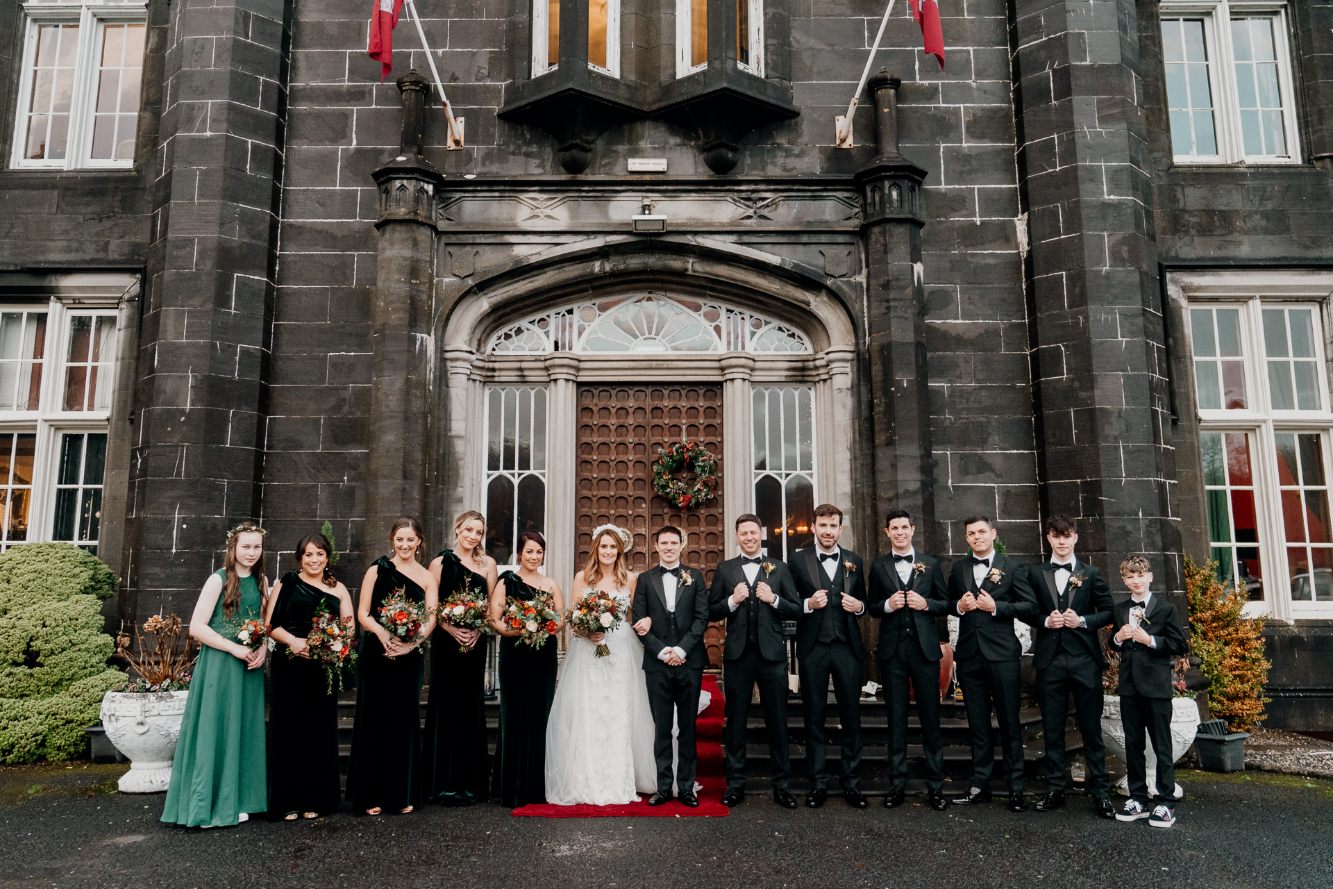 A group of people posing for a photo in front of a building