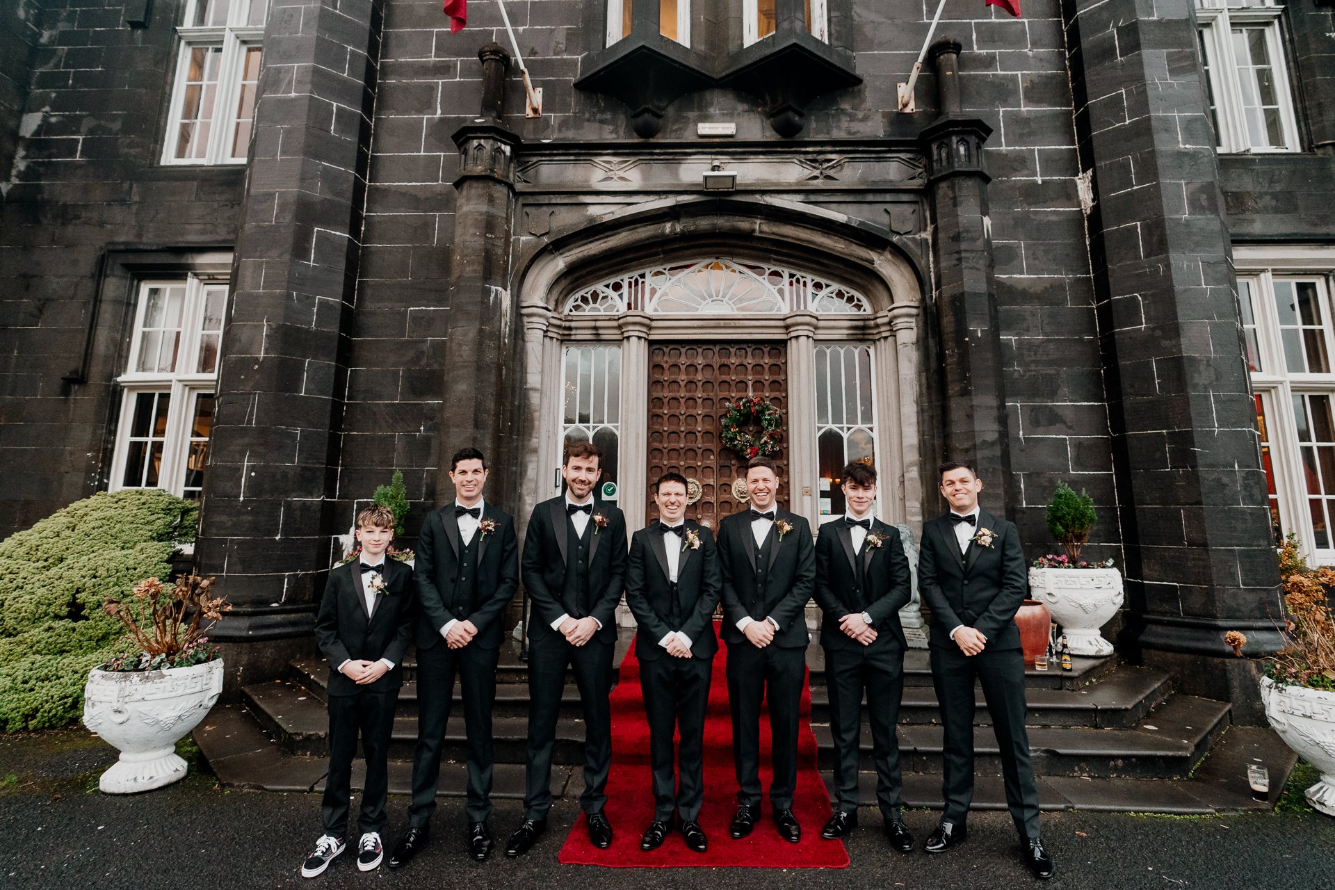 A group of men in suits posing for a photo