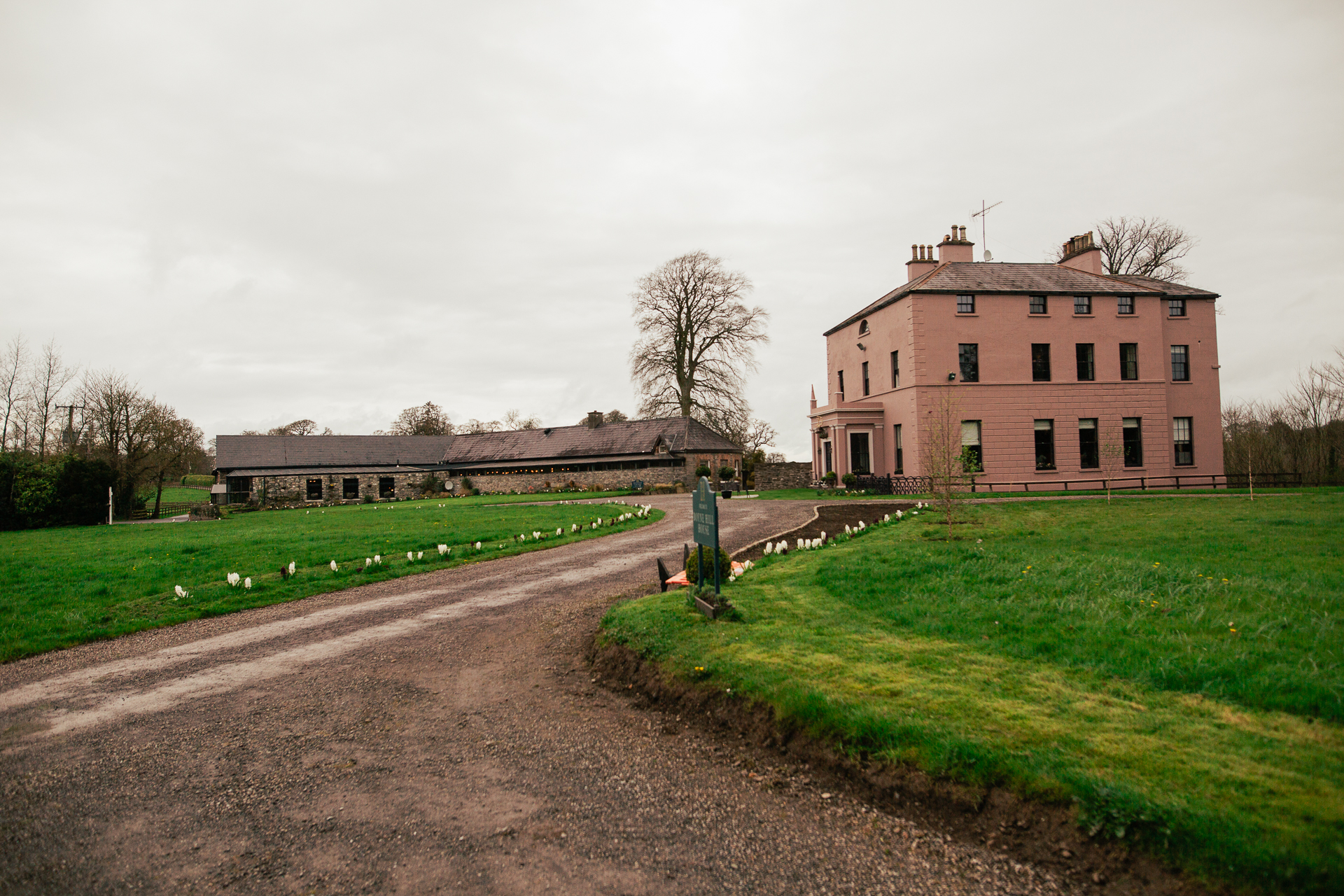 A dirt road leading to a building