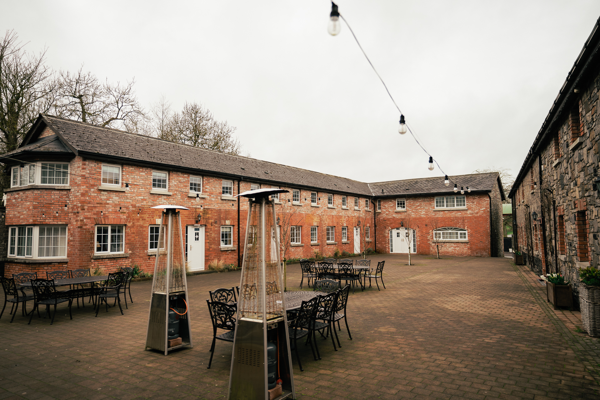 A brick building with tables and chairs