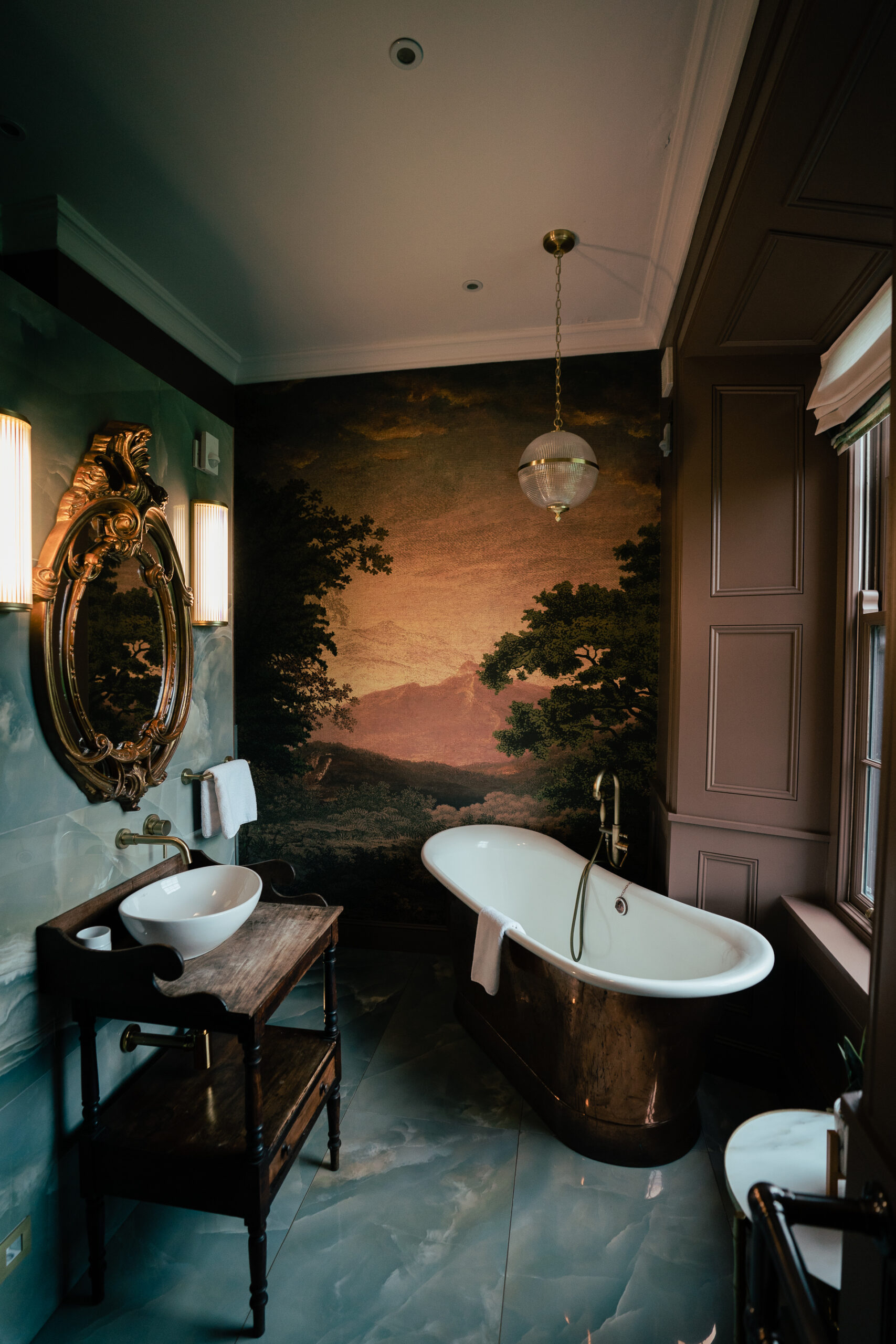 A bathroom with a tub sink and a mirror