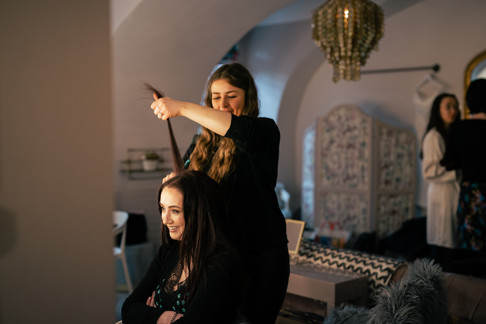 A person cutting another woman's hair