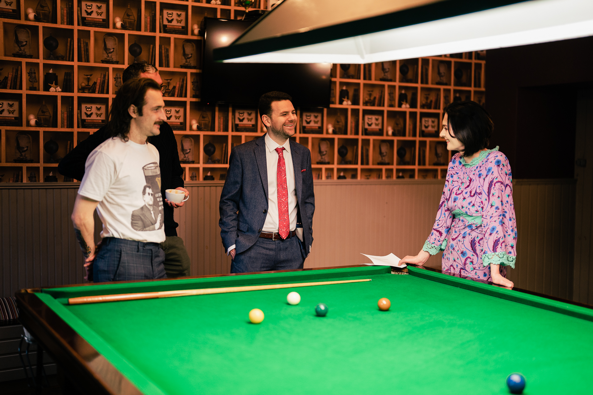 A group of people playing pool