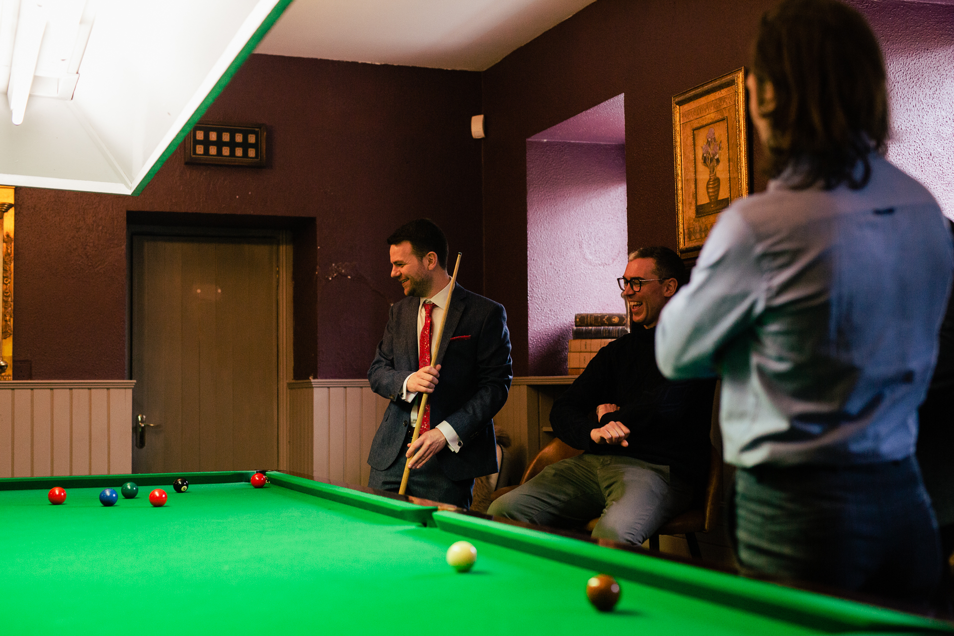 A group of people playing pool