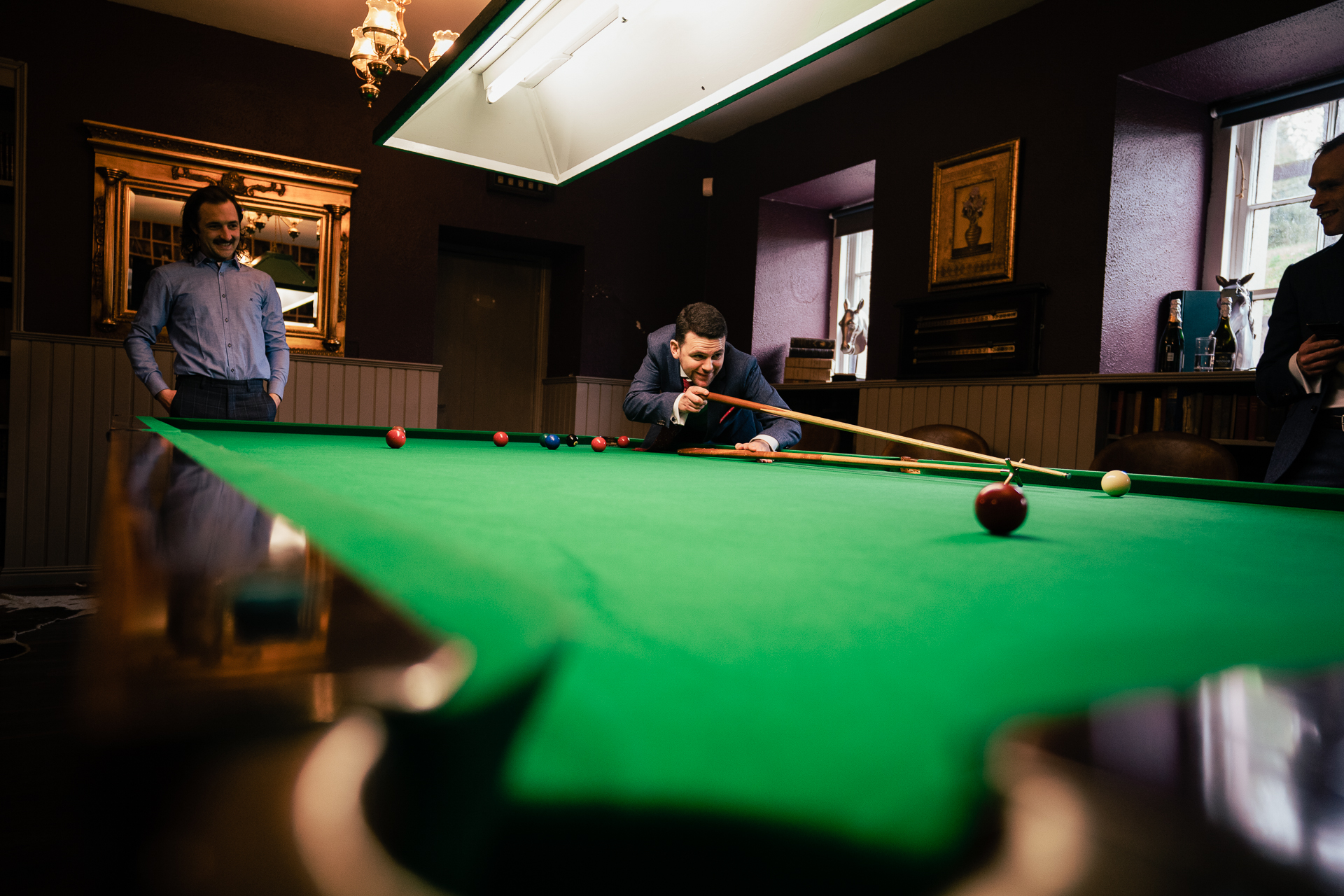 A group of men playing pool