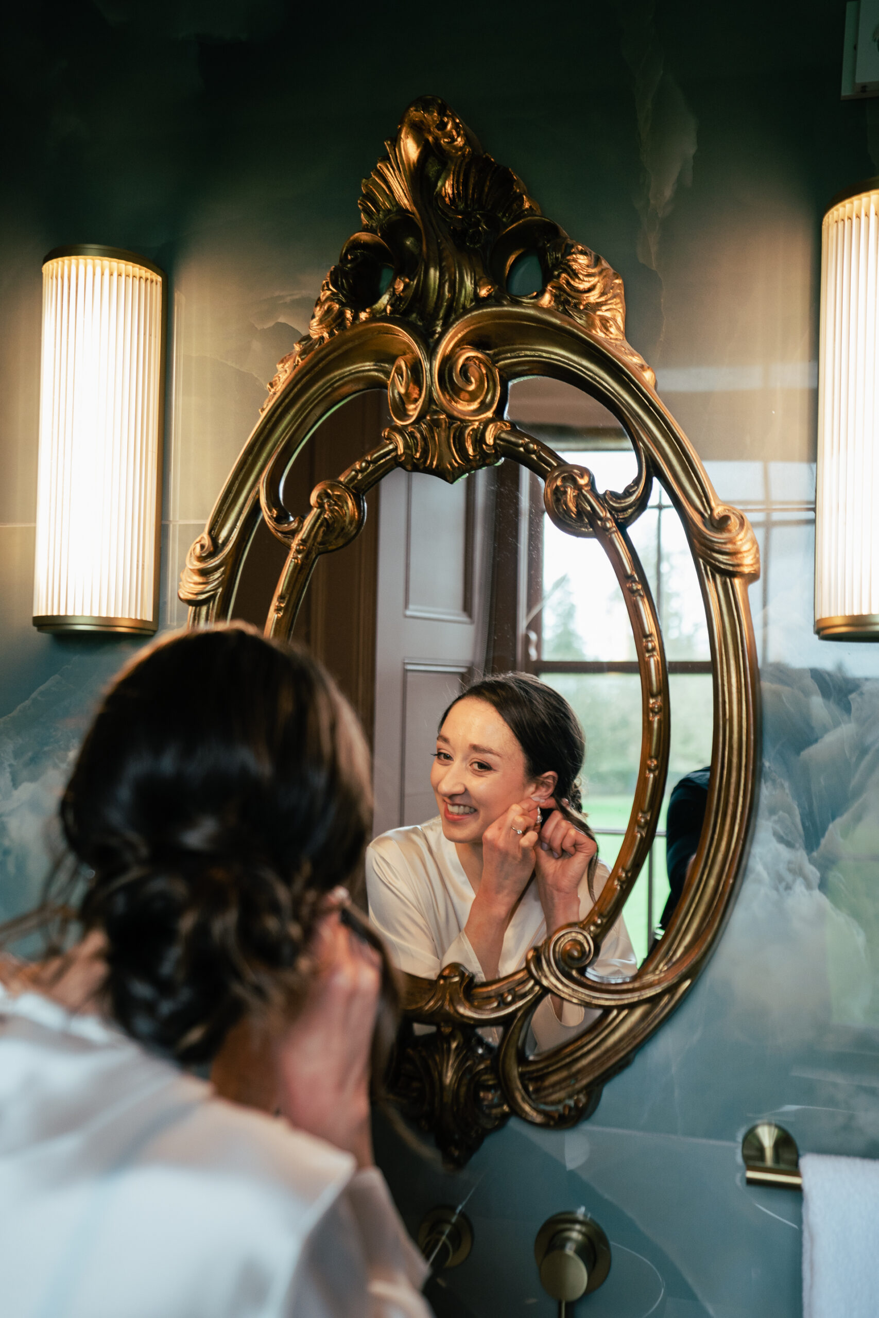 A person talking on a cell phone in front of a mirror