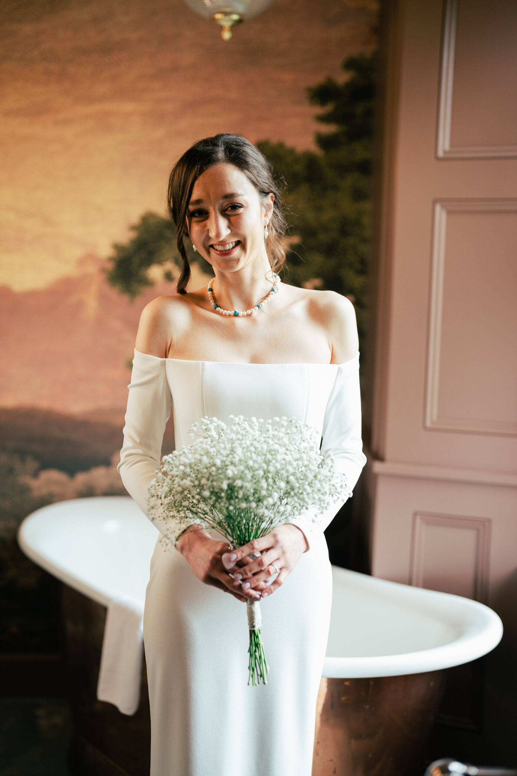 A woman in a wedding dress holding a bouquet of flowers