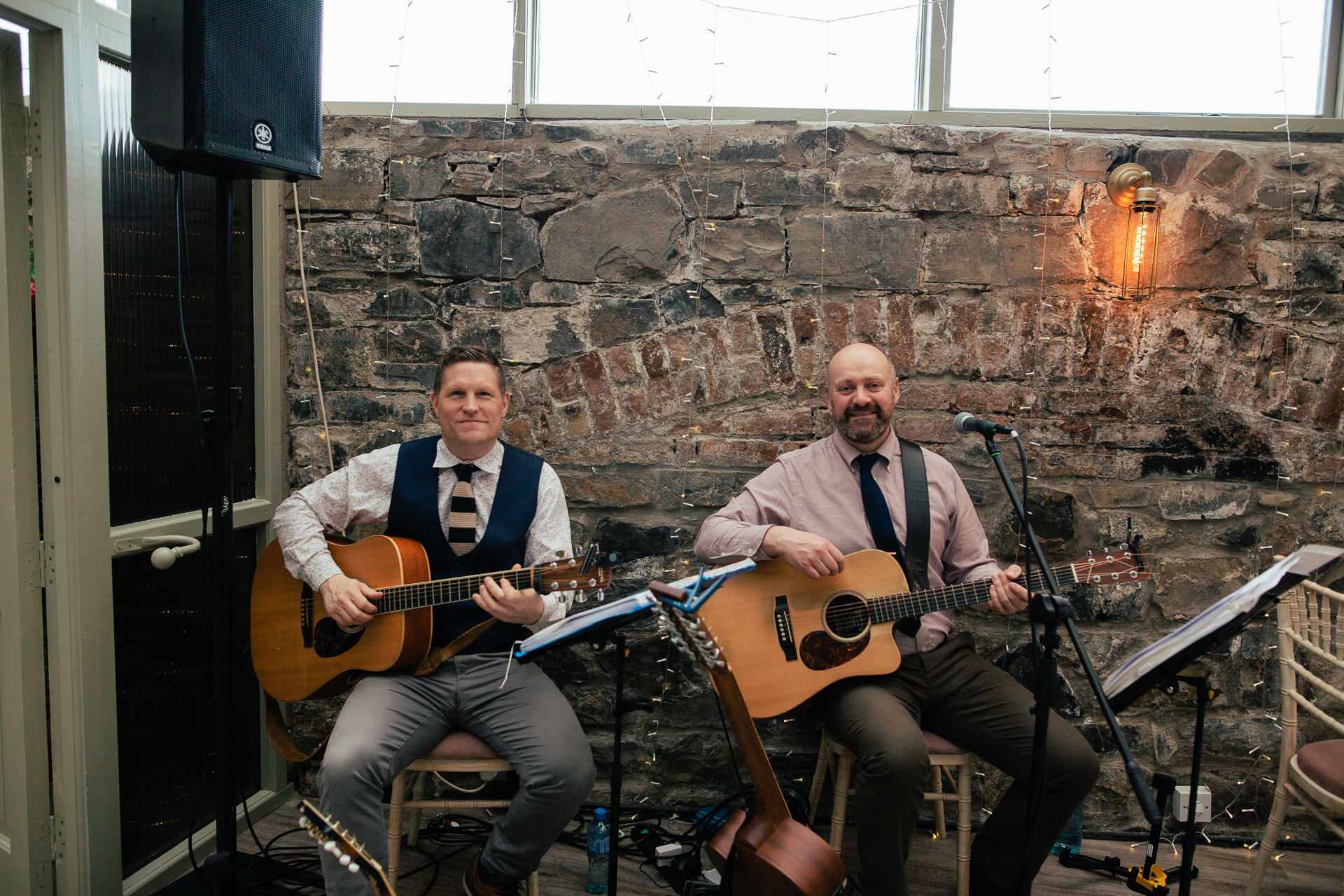 Two men playing guitars