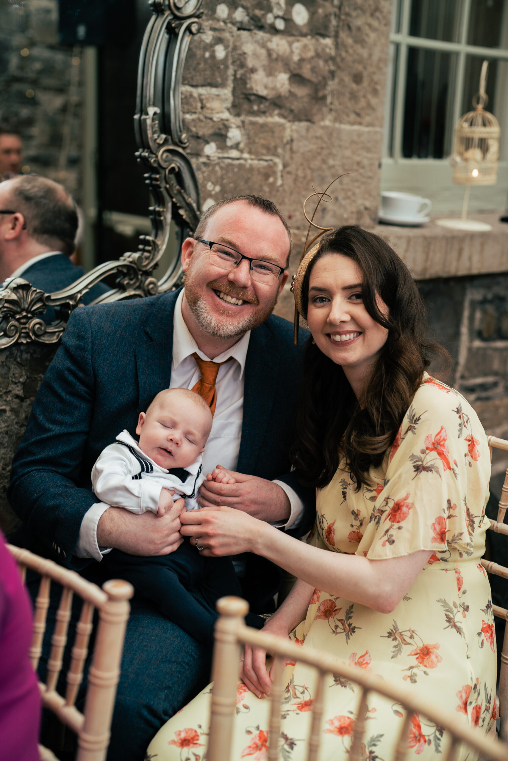 A man and woman holding a baby