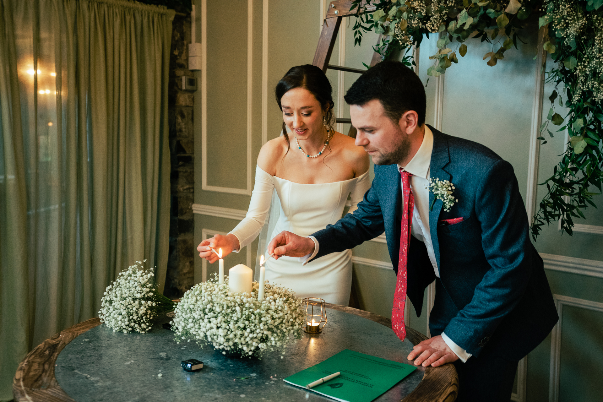 A bride and groom cutting a cake