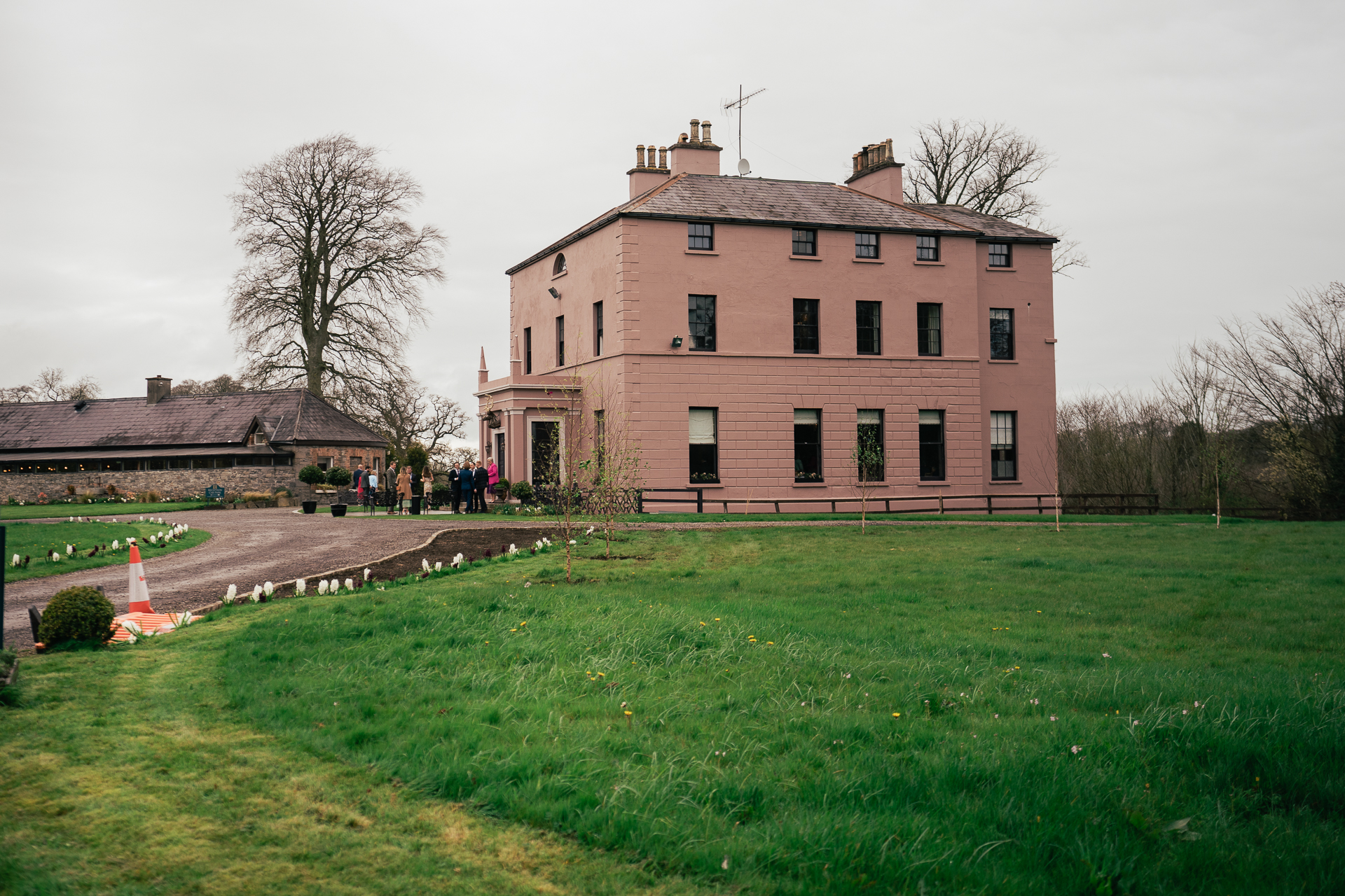 A large brick building with a lawn in front of it