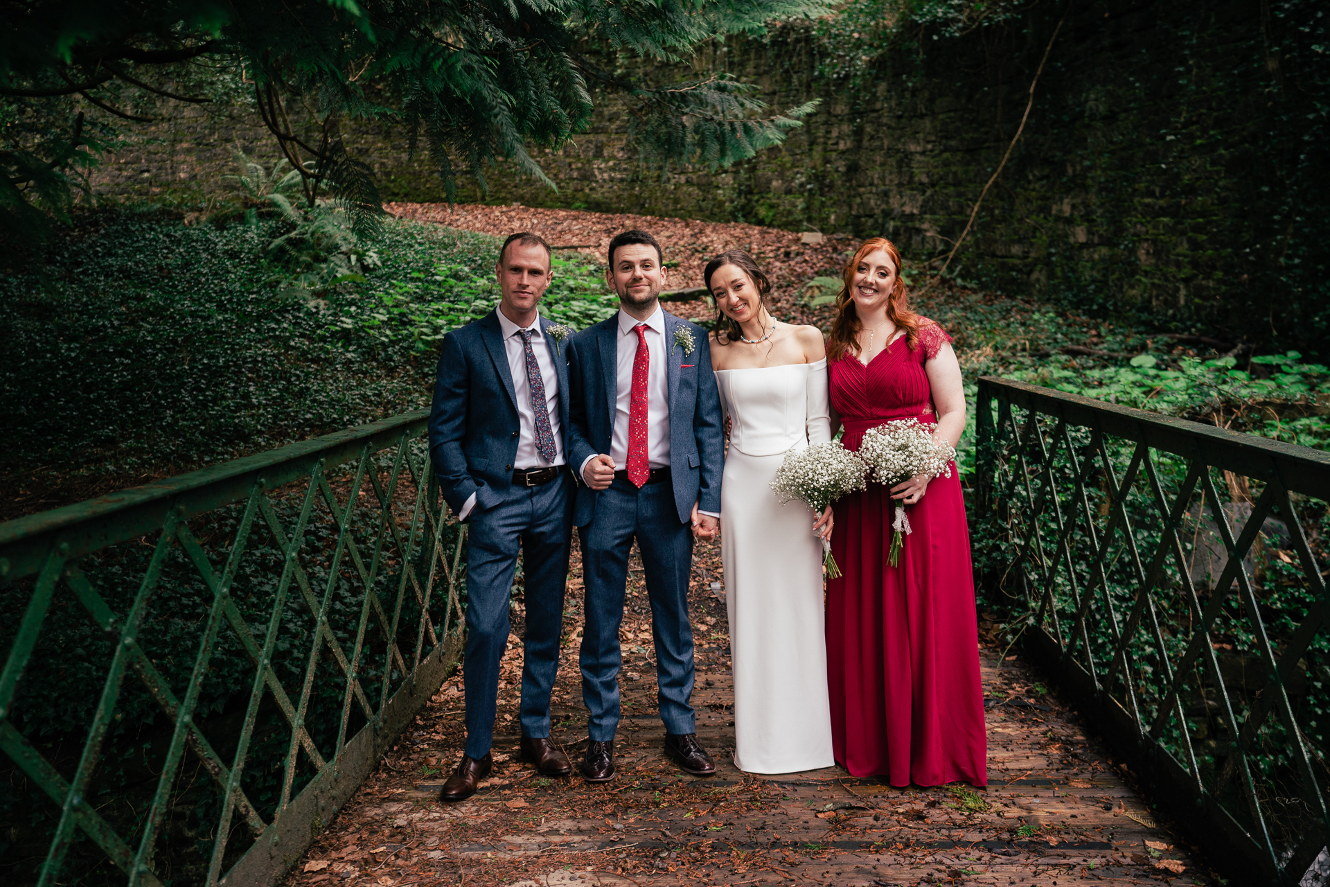 A group of people posing for a photo on a bridge