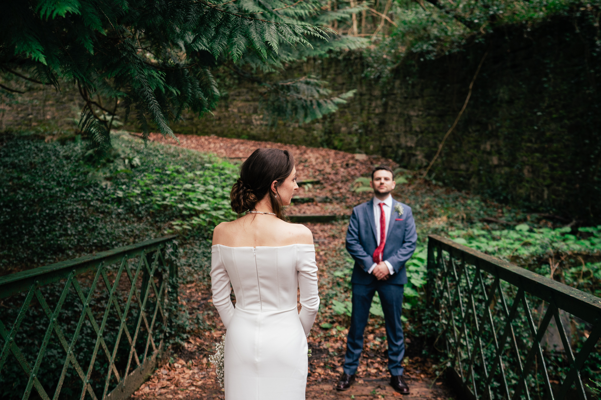 A man and woman walking on a bridge