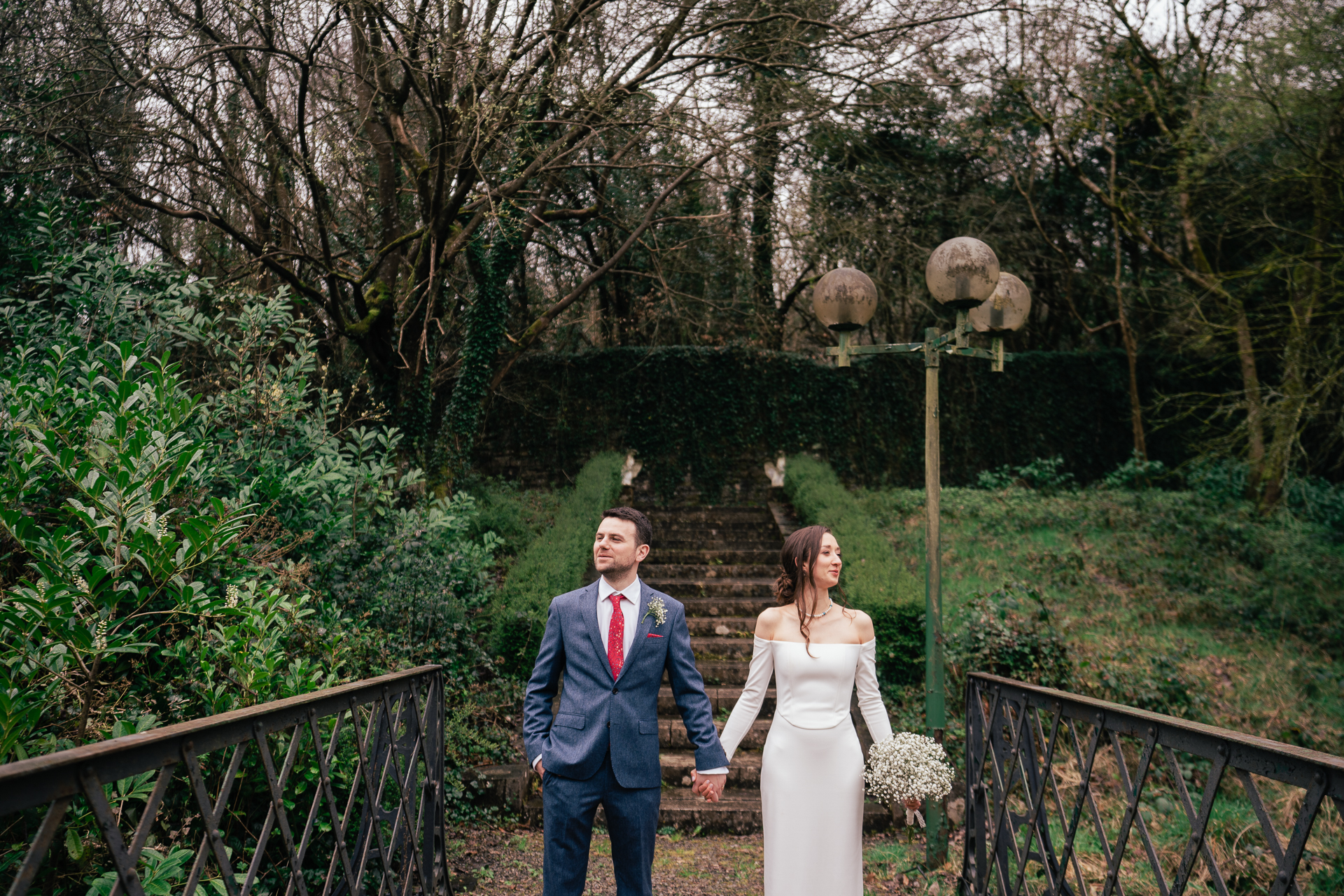 A man and woman walking down a bridge