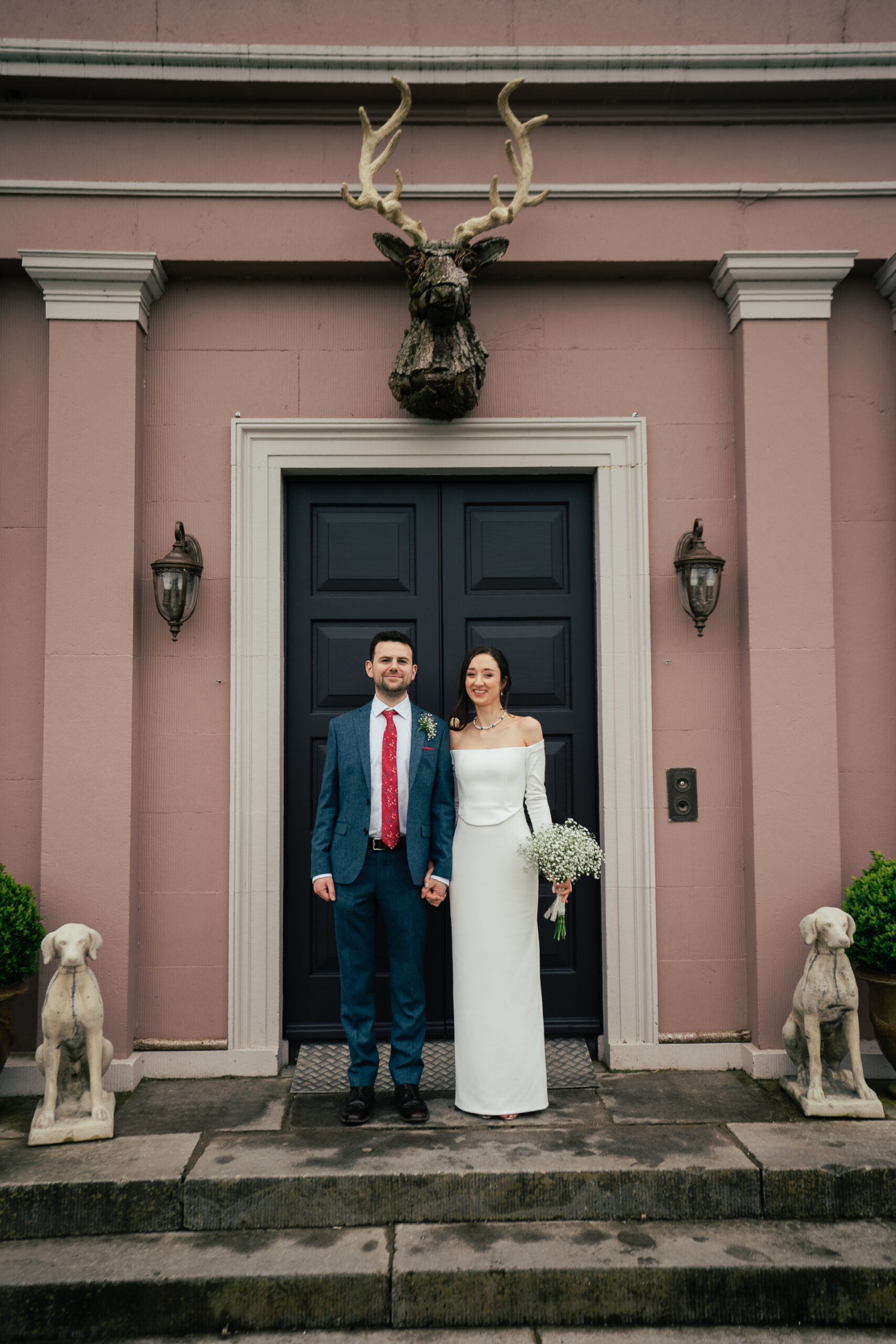 A man and woman standing in front of a door