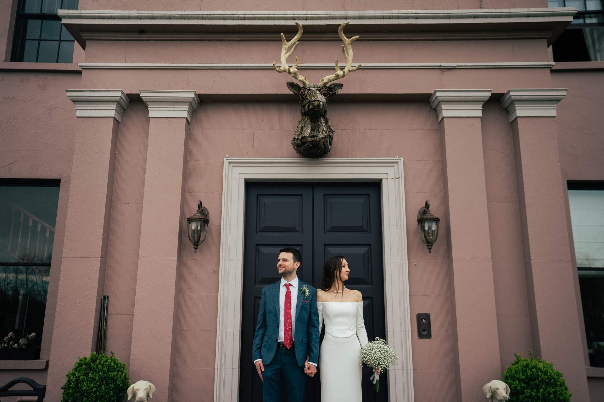 A man and woman posing for a picture in front of a building