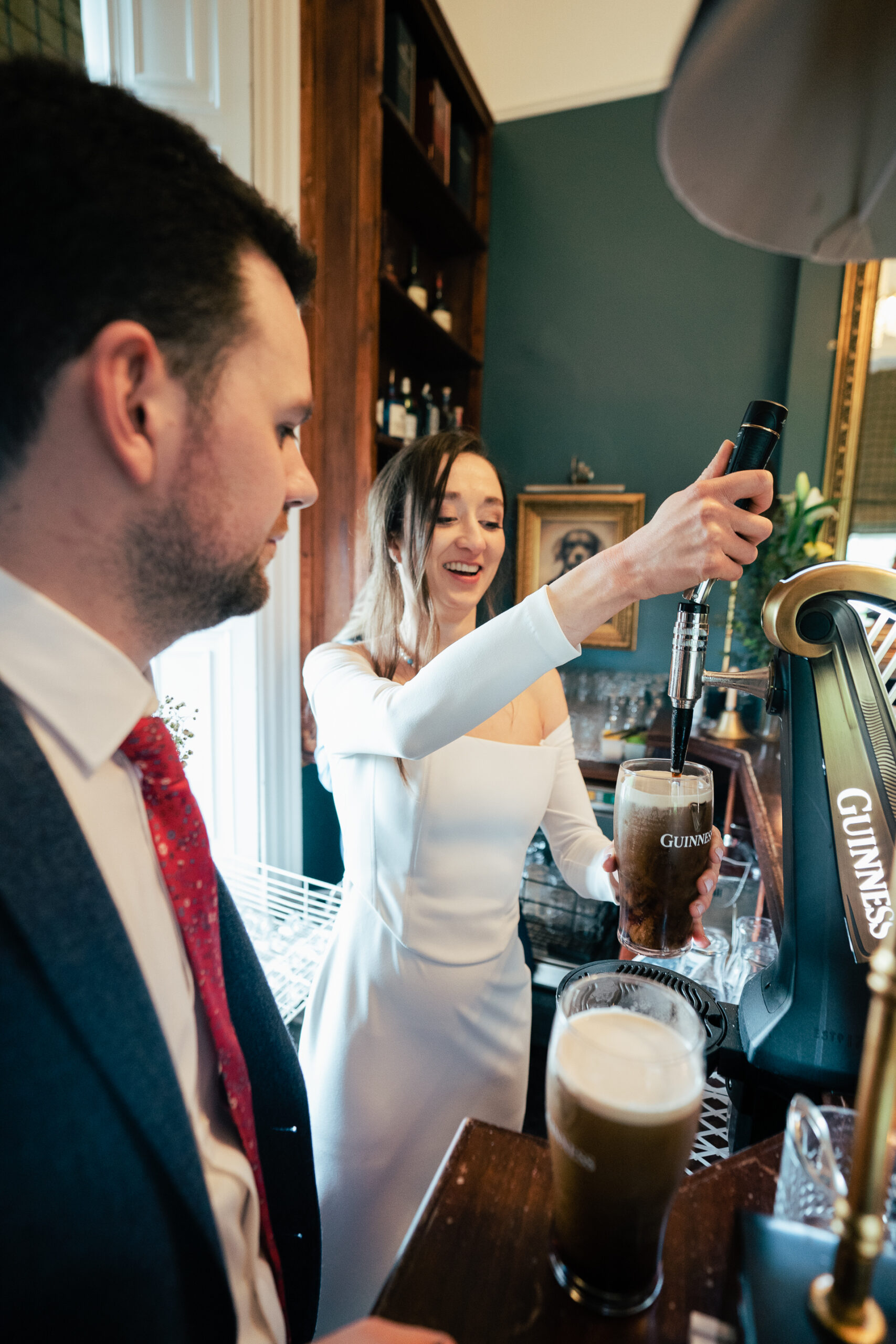 A man and woman holding a bottle of champagne