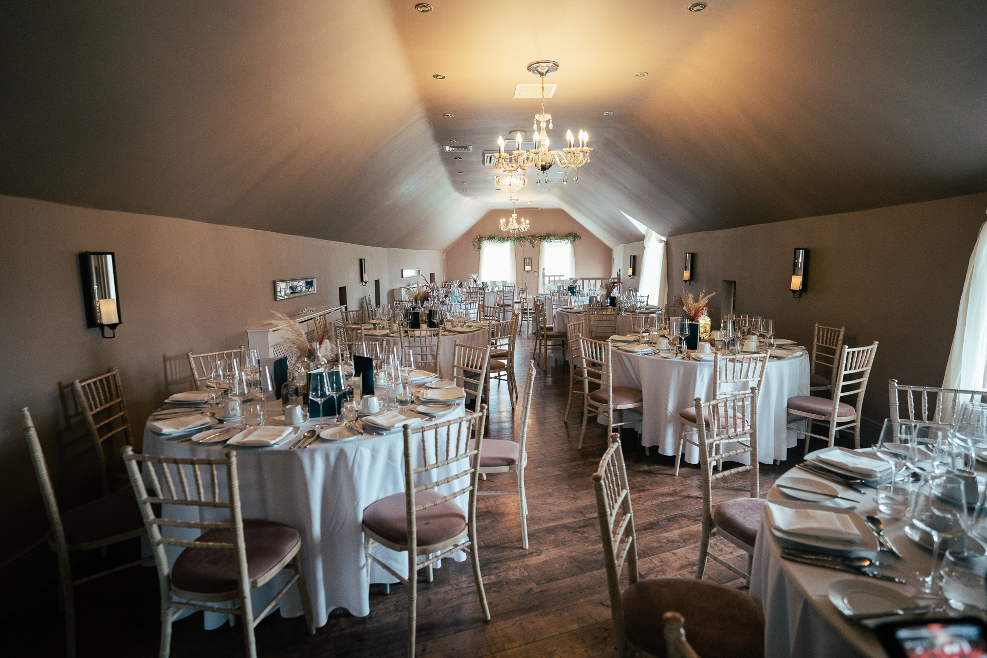 A large room with tables set for a meal