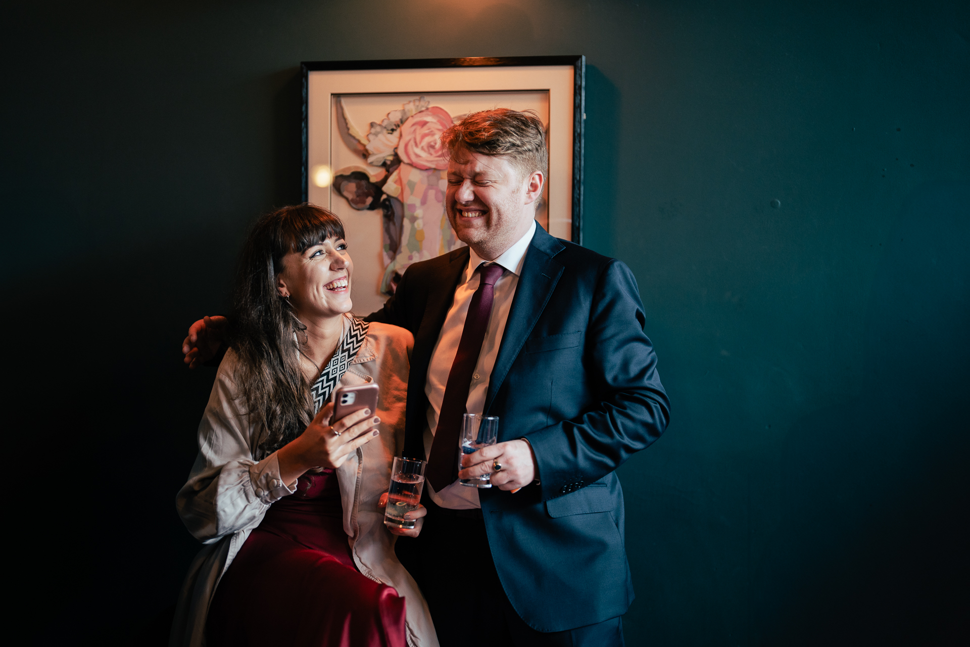 A man and woman holding drinks