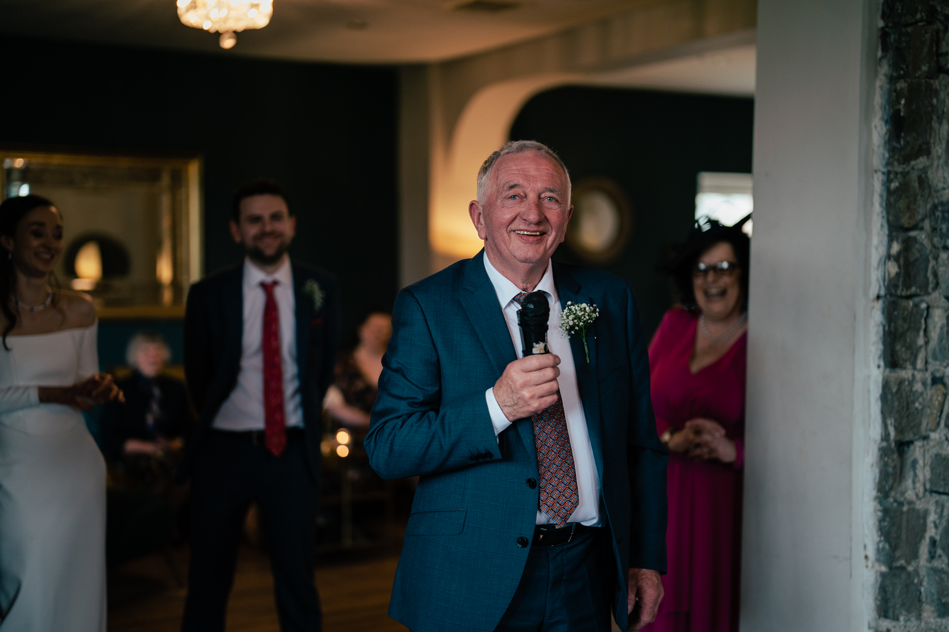 A man in a suit speaking into a microphone