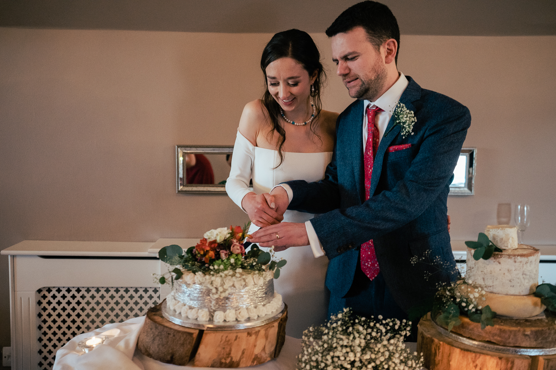 A bride and groom cutting a cake