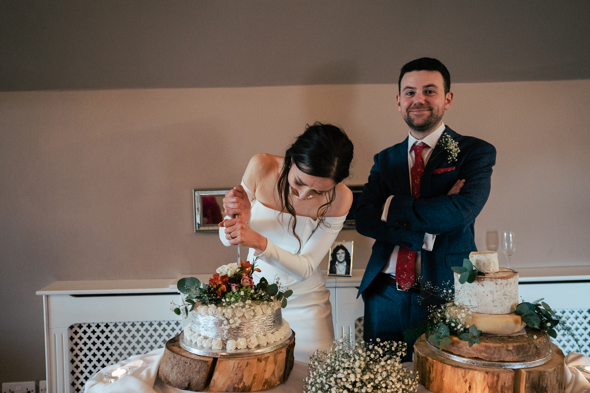 A bride and groom cutting a wedding cake