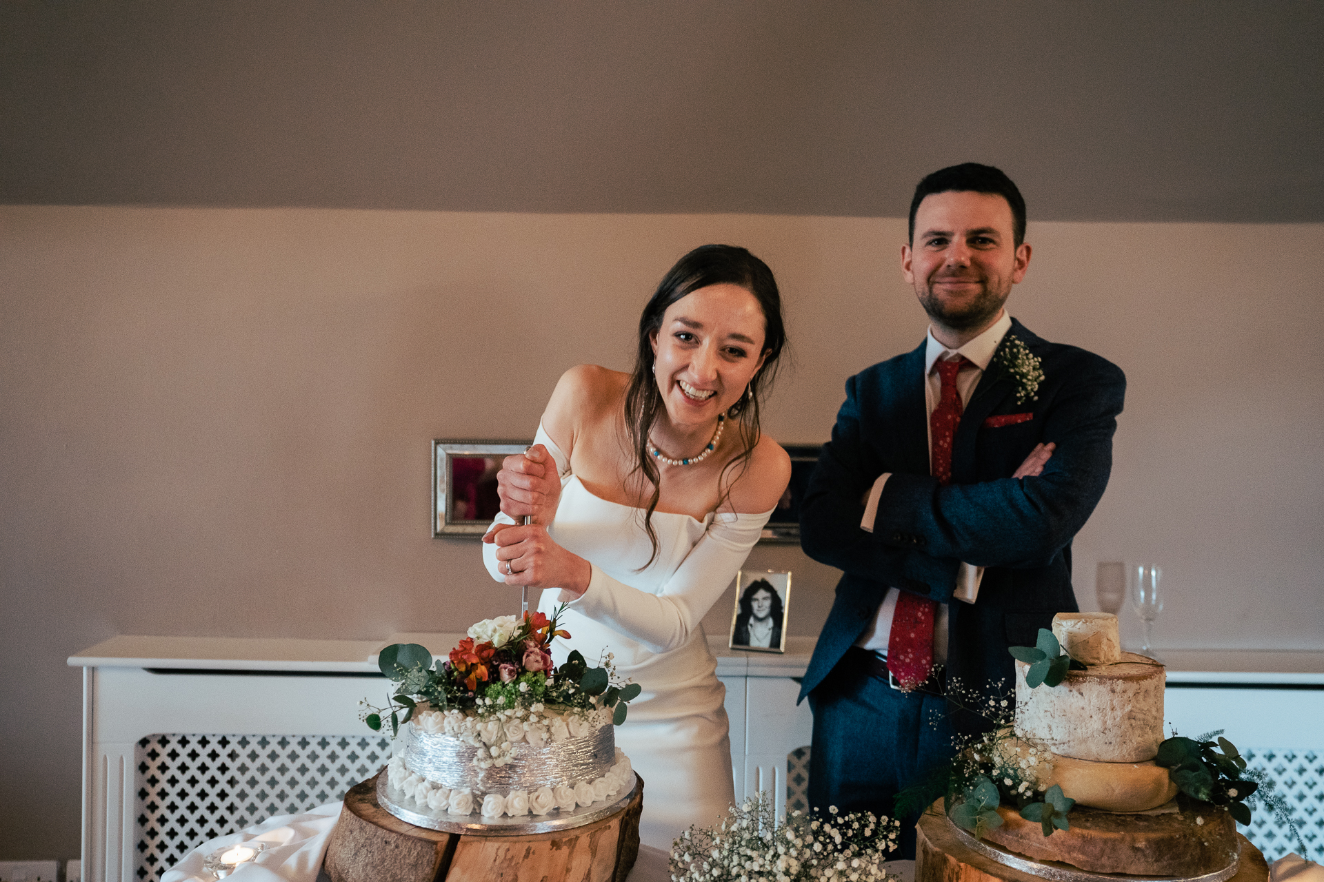 A bride and groom cutting a wedding cake