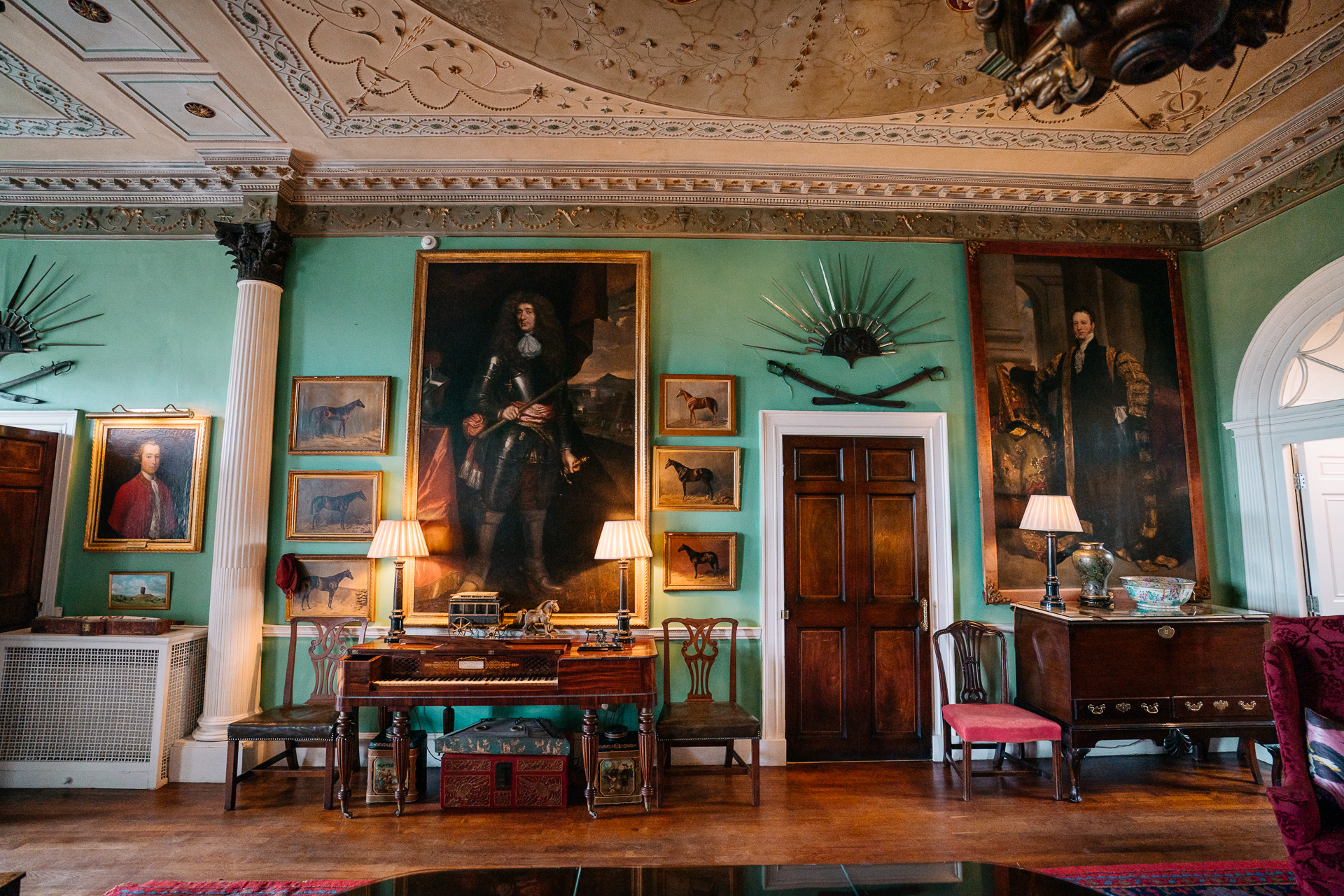 A room with a desk and a painting on the wall