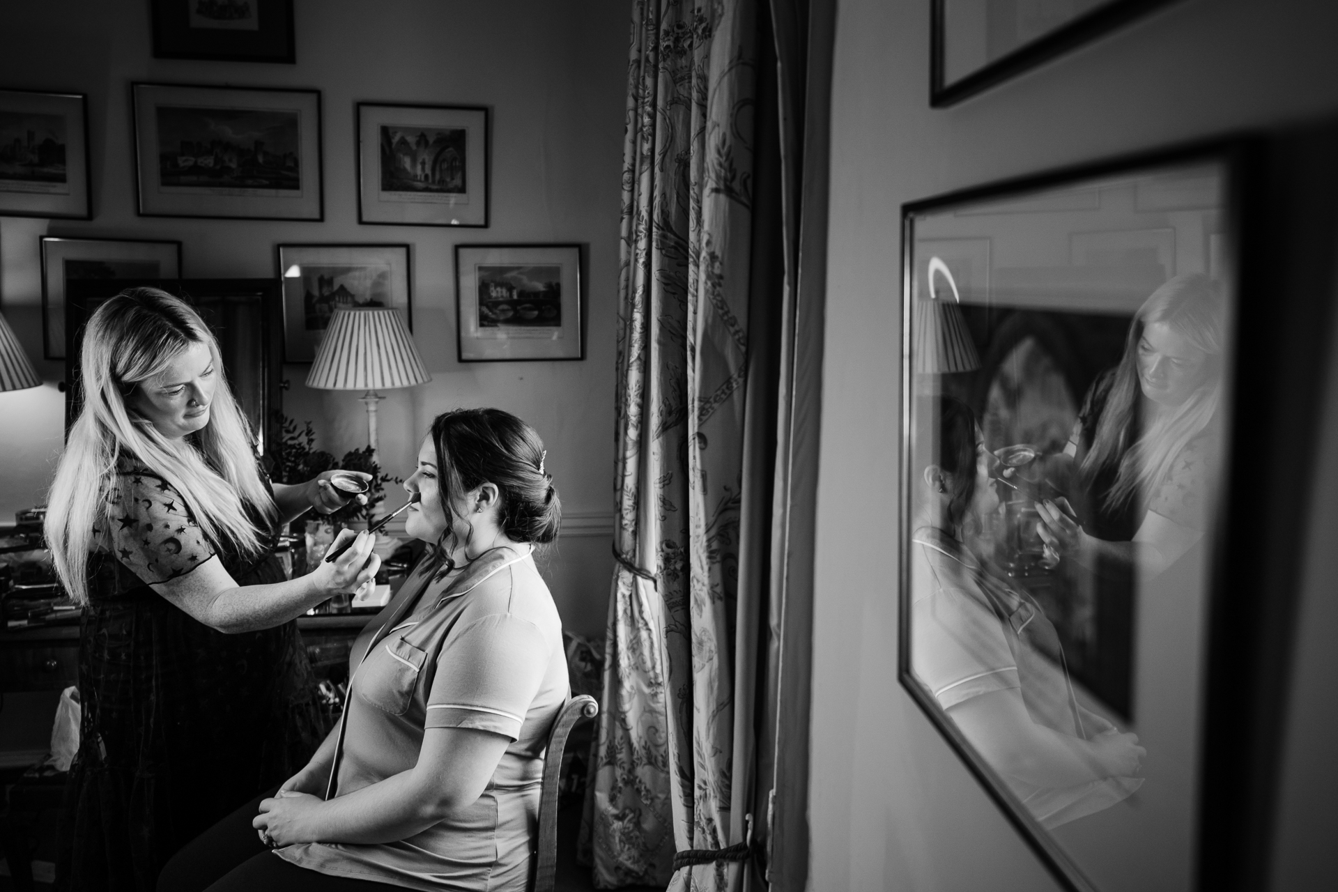 A woman looking at a picture on the wall