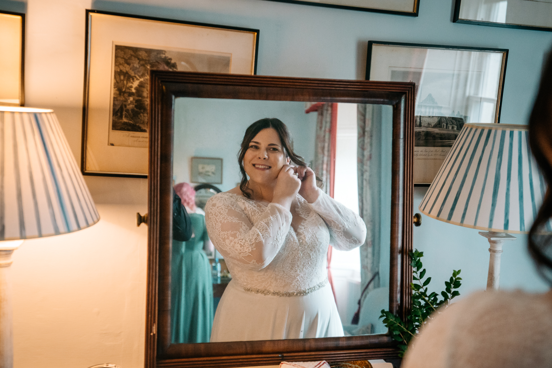 A person in a wedding dress in front of a mirror