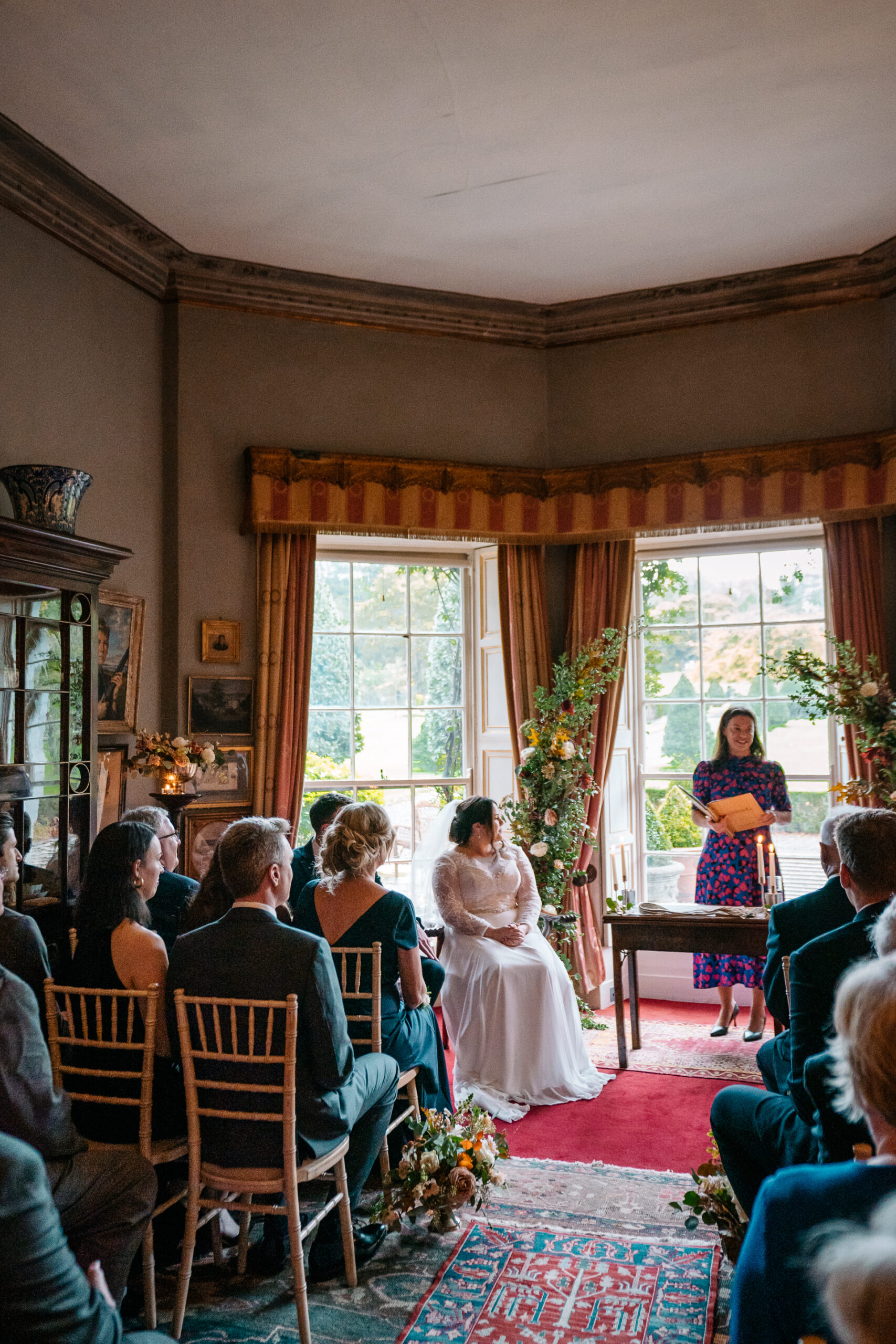 Romantic wedding ceremony set in the picturesque gardens of Glin Castle, surrounded by lush greenery and timeless elegance