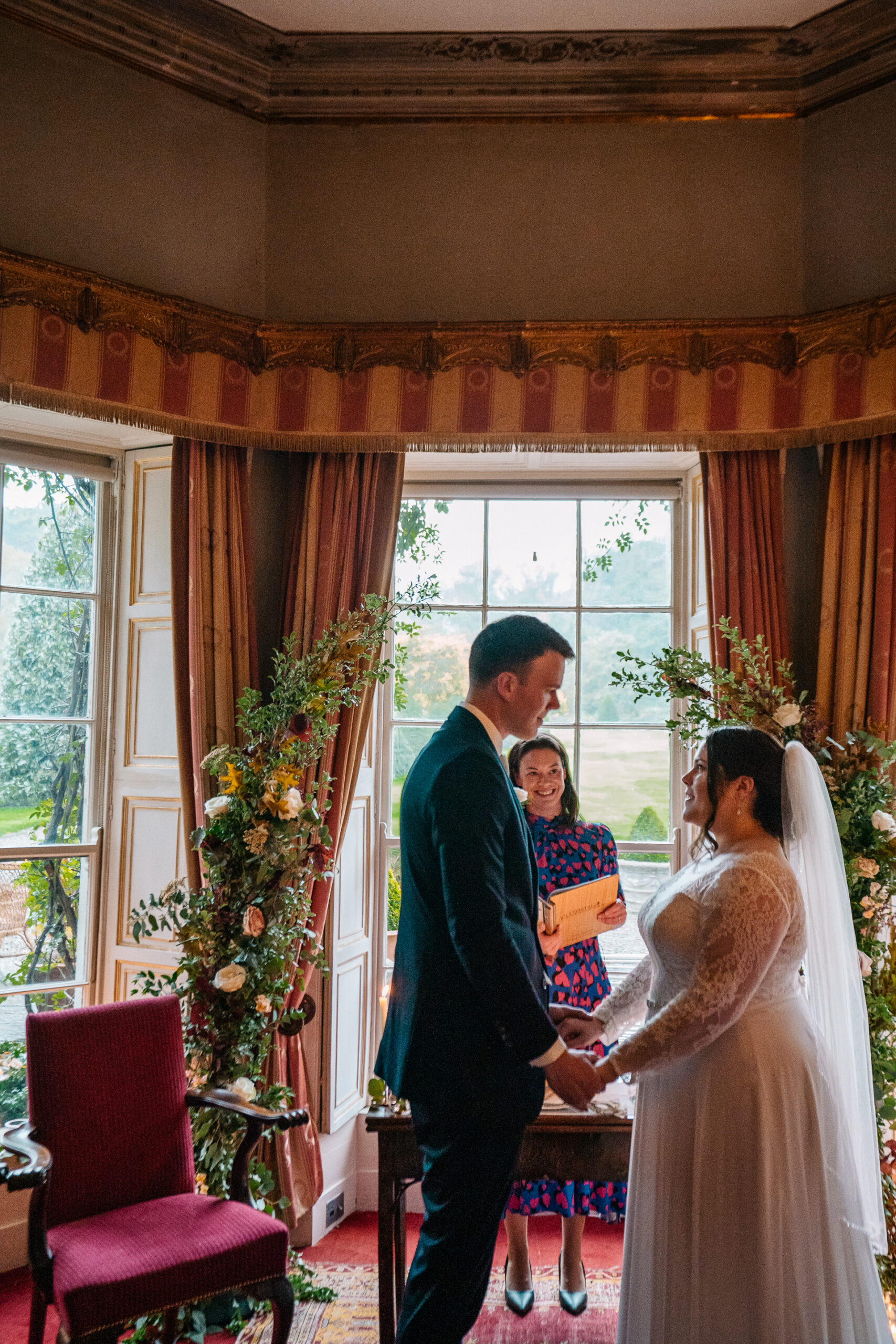 Romantic wedding ceremony set in the picturesque gardens of Glin Castle, surrounded by lush greenery and timeless elegance