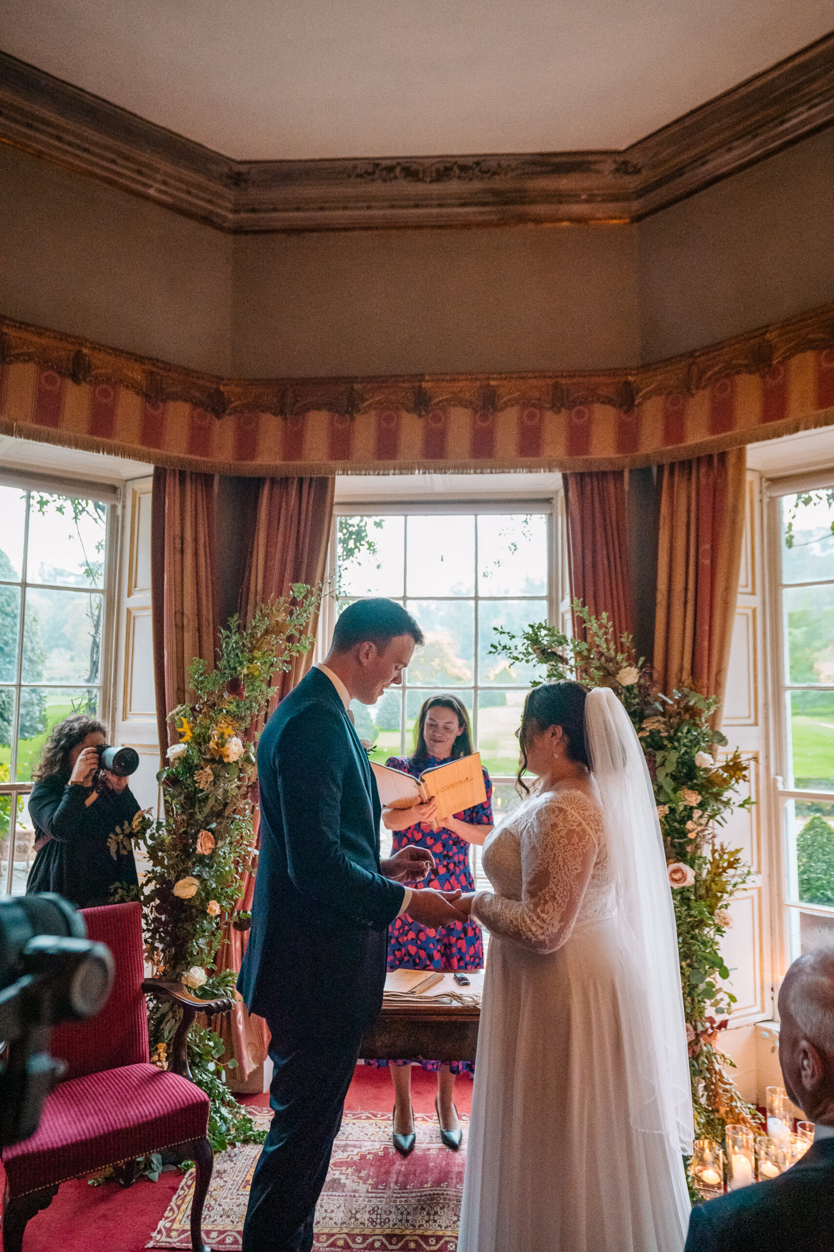 Romantic wedding ceremony set in the picturesque gardens of Glin Castle, surrounded by lush greenery and timeless elegance