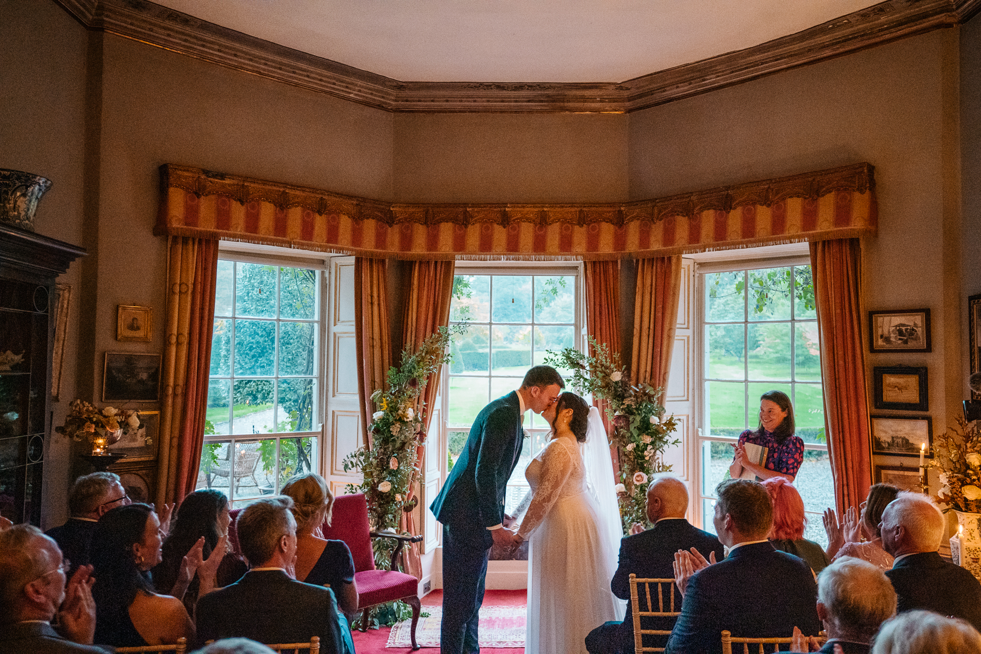 A bride and groom dancing in a room full of people