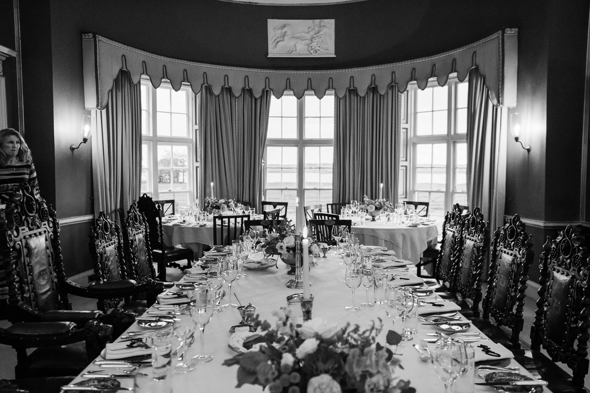 A dining room with tables set for a meal