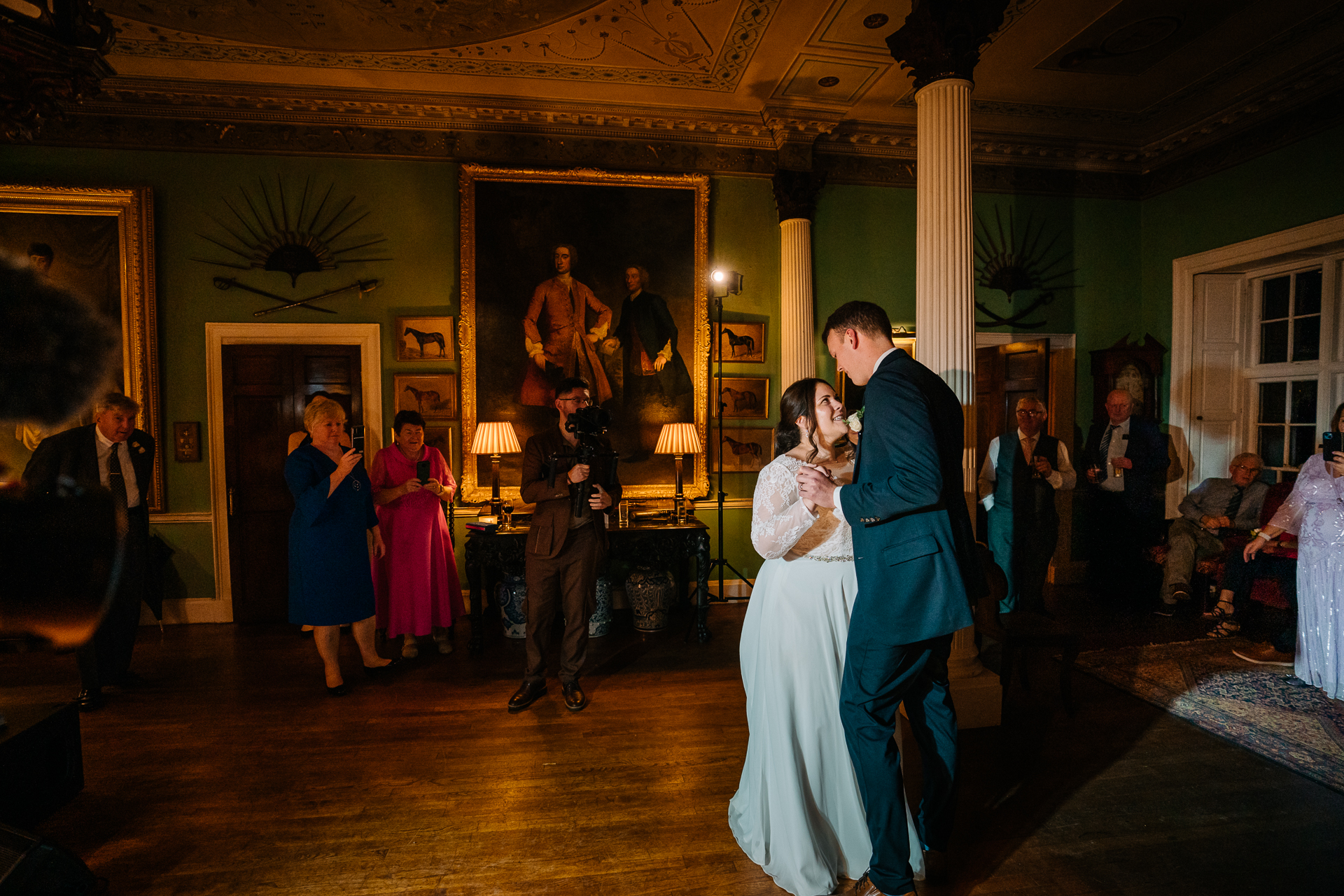 A man and woman dancing in a room with a group of people