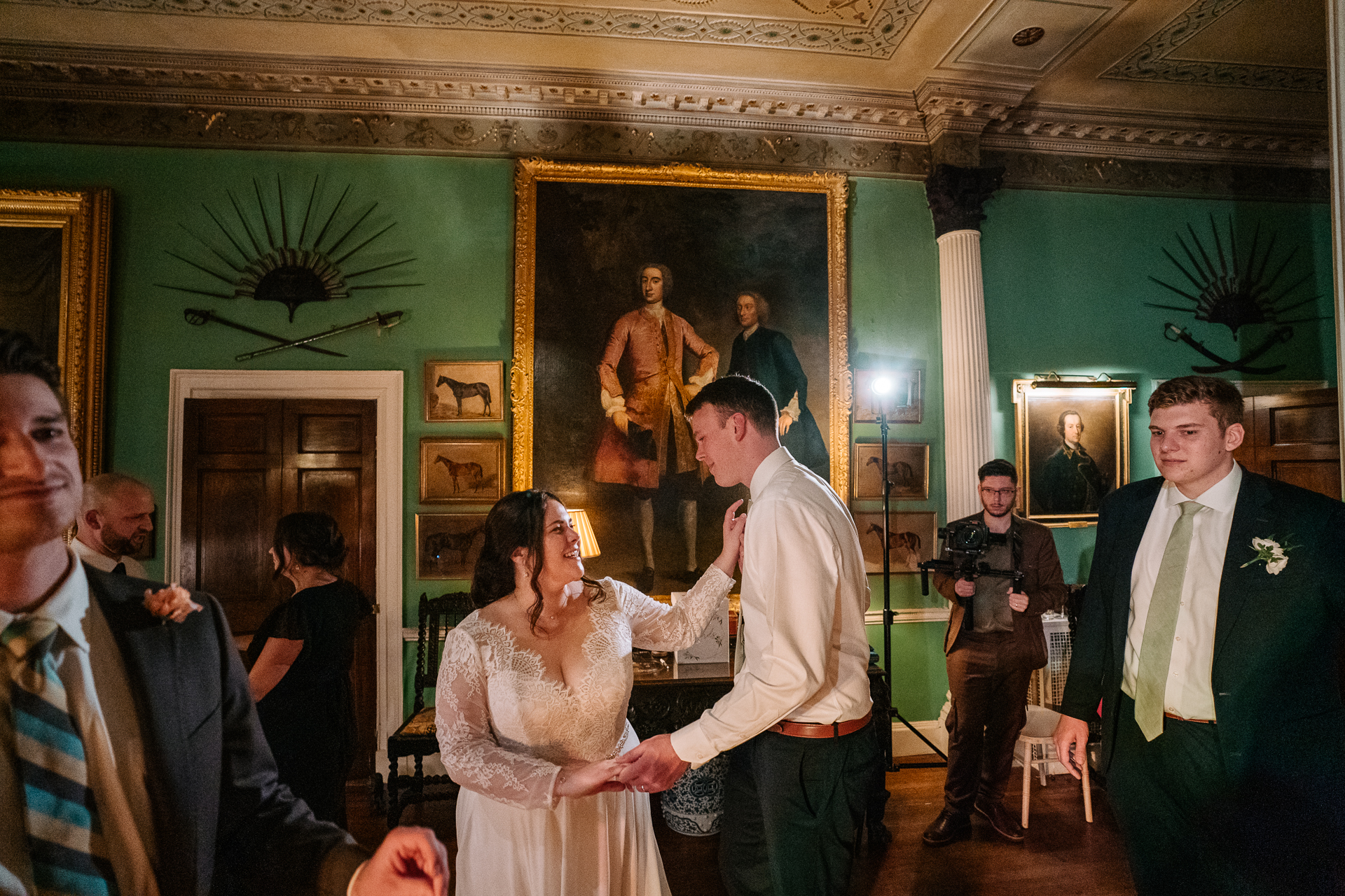 A man and woman dancing in a room with other people