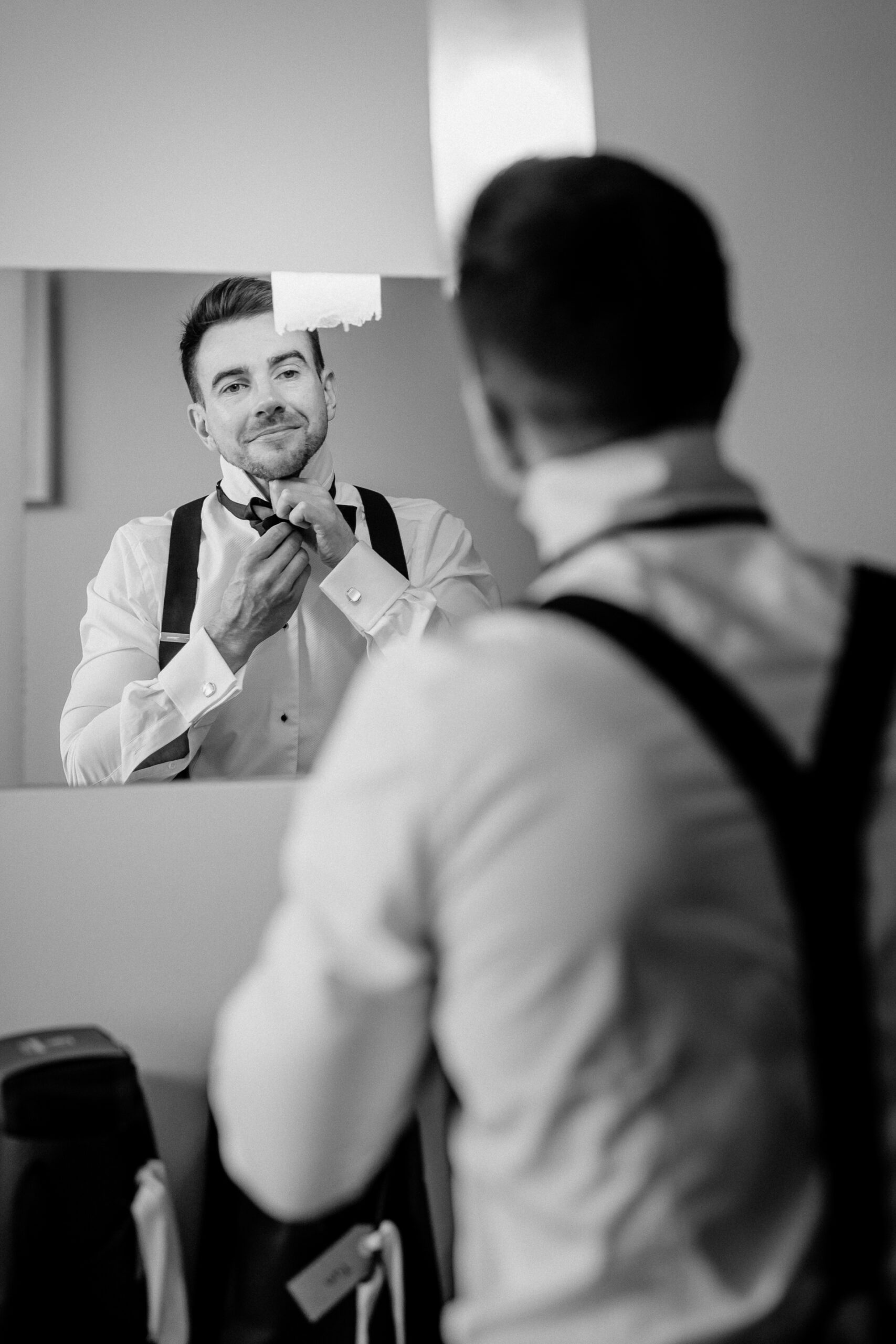 A man adjusting his tie