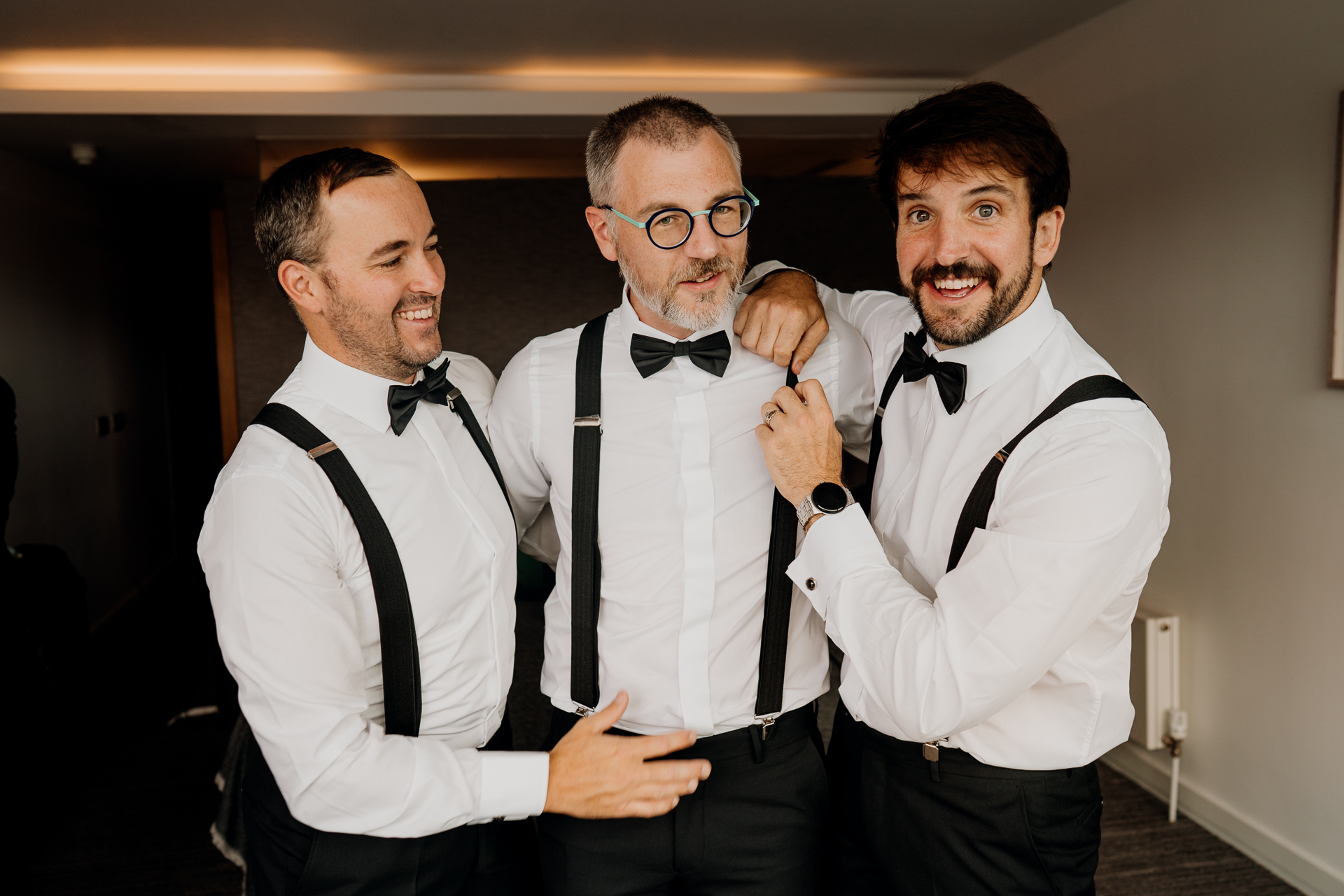 A group of men wearing suspenders