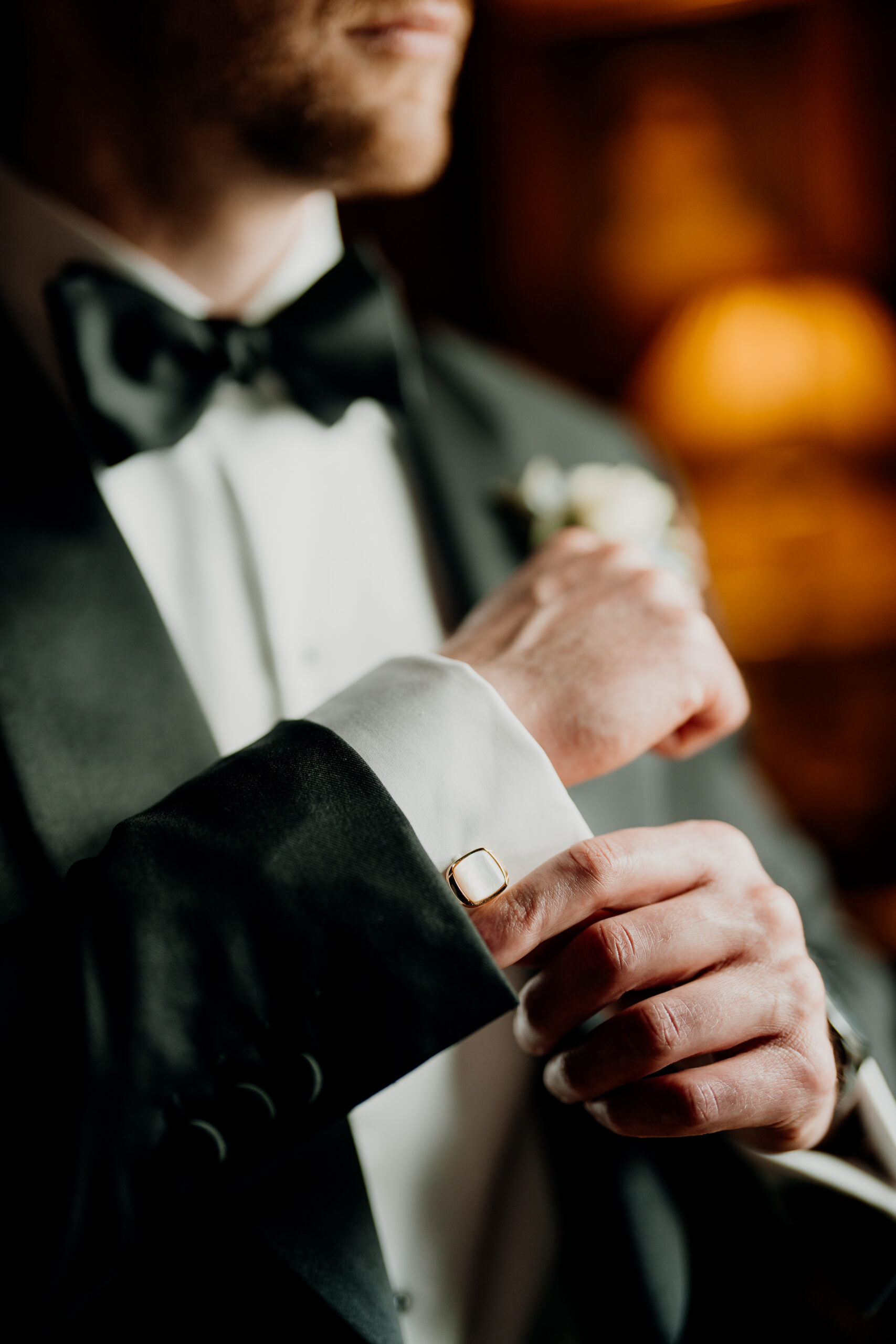 A man in a tuxedo holding a bouquet of flowers