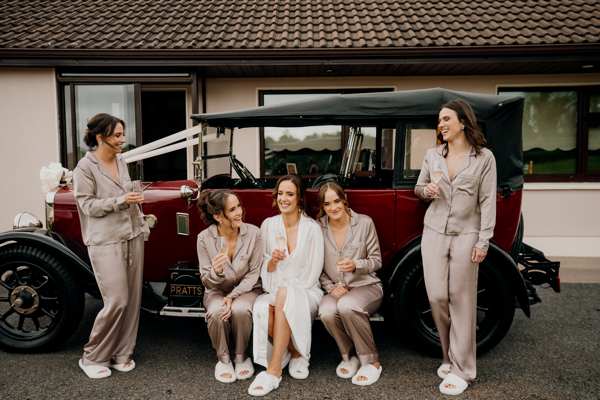 A group of women posing for a picture in front of a van