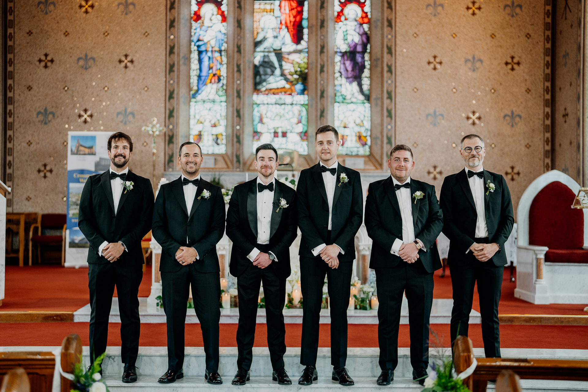 A group of men in suits standing on a stage