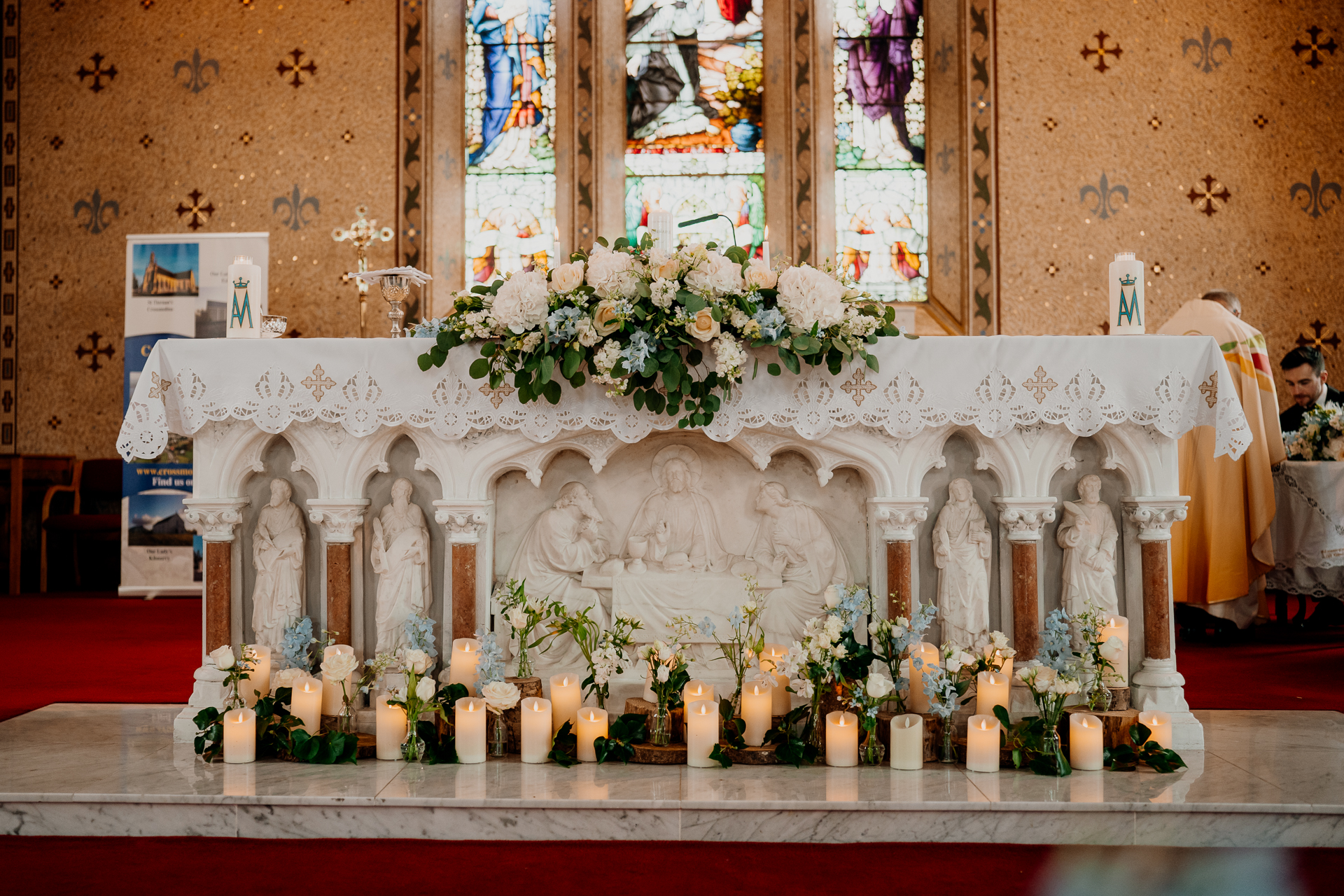 A religious shrine with candles and flowers