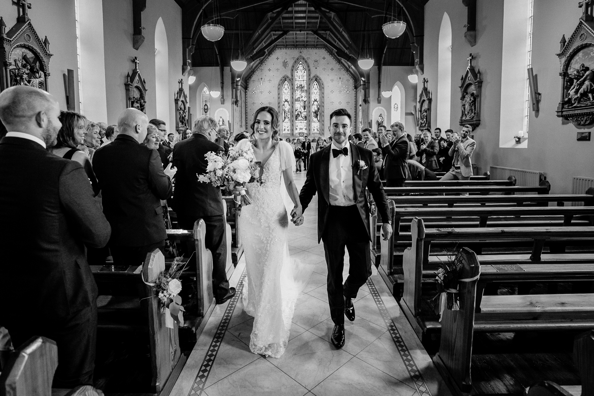 A bride and groom walking down the aisle