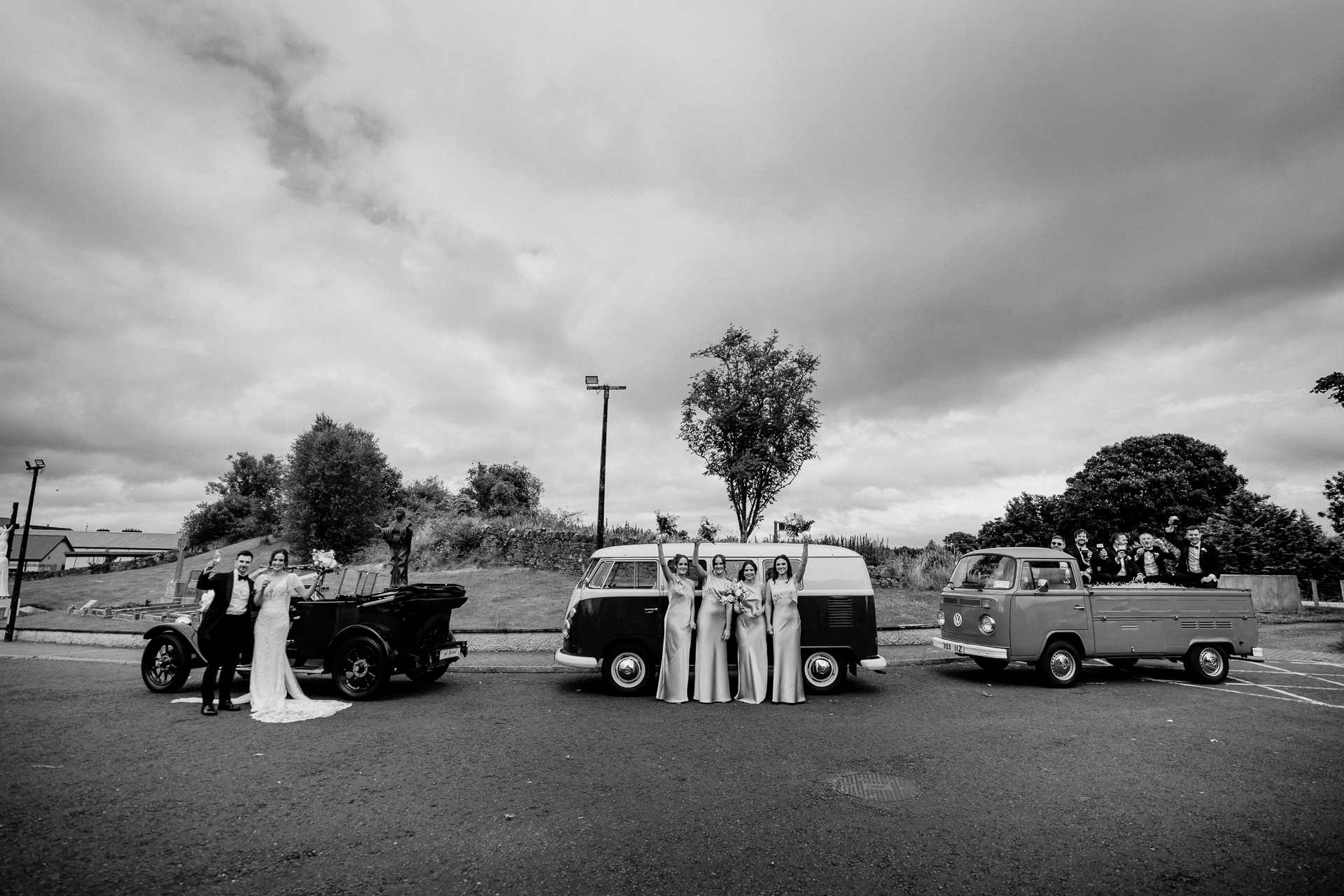 A group of people standing next to a car with a coffin on it