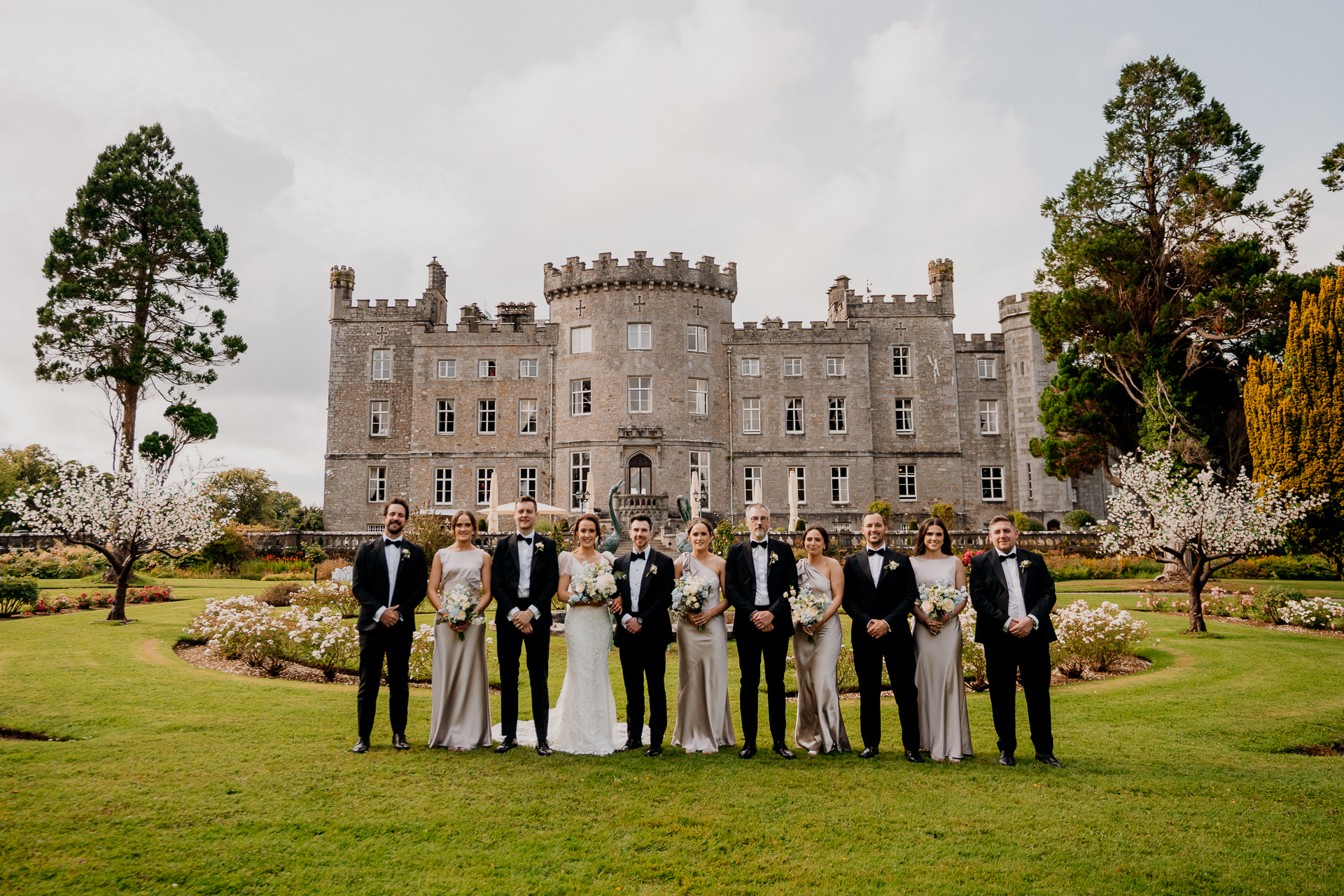 A group of people posing for a photo in front of a large building